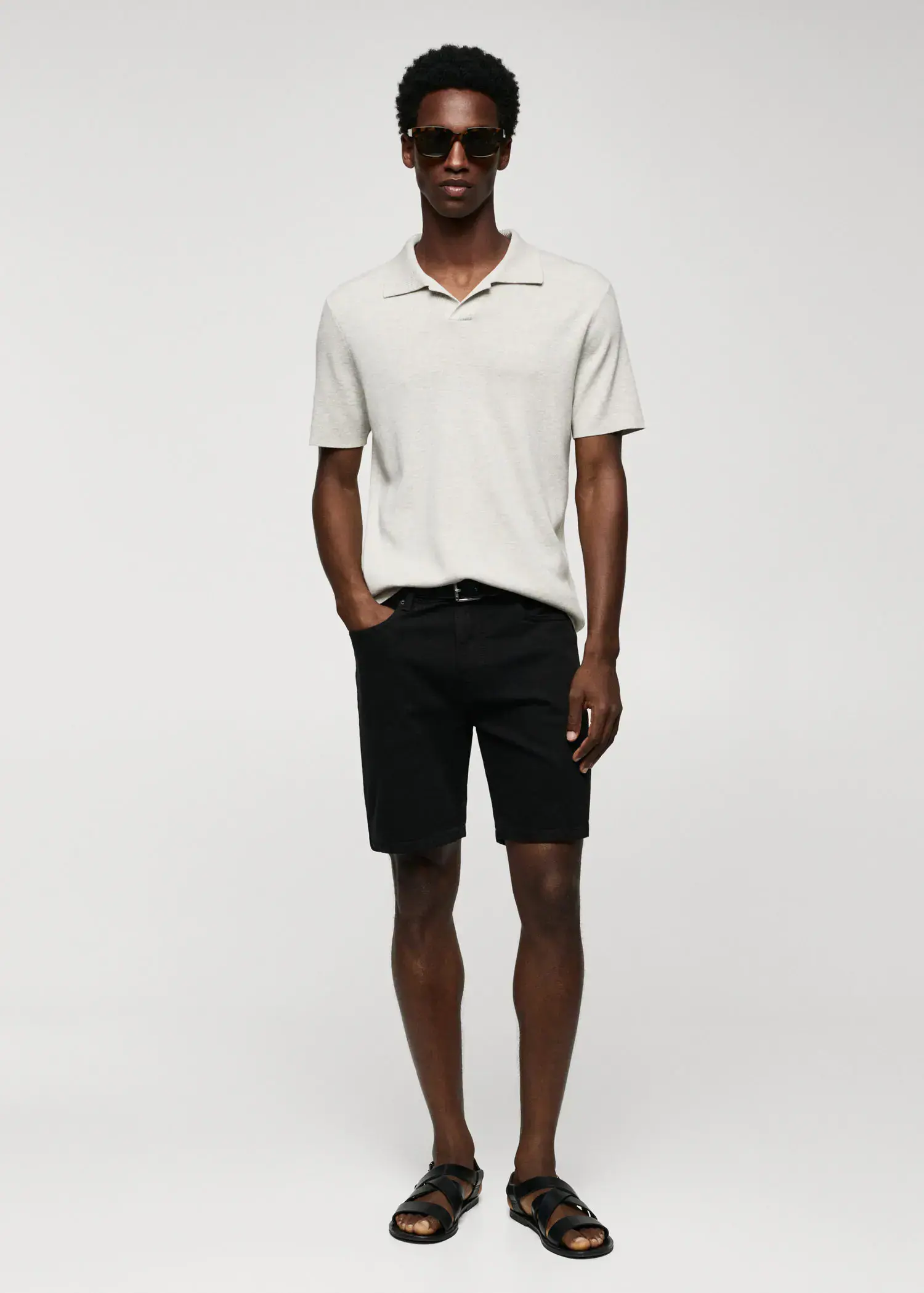 Mango Regular-fit denim bermuda shorts. a man in a white shirt and black shorts. 