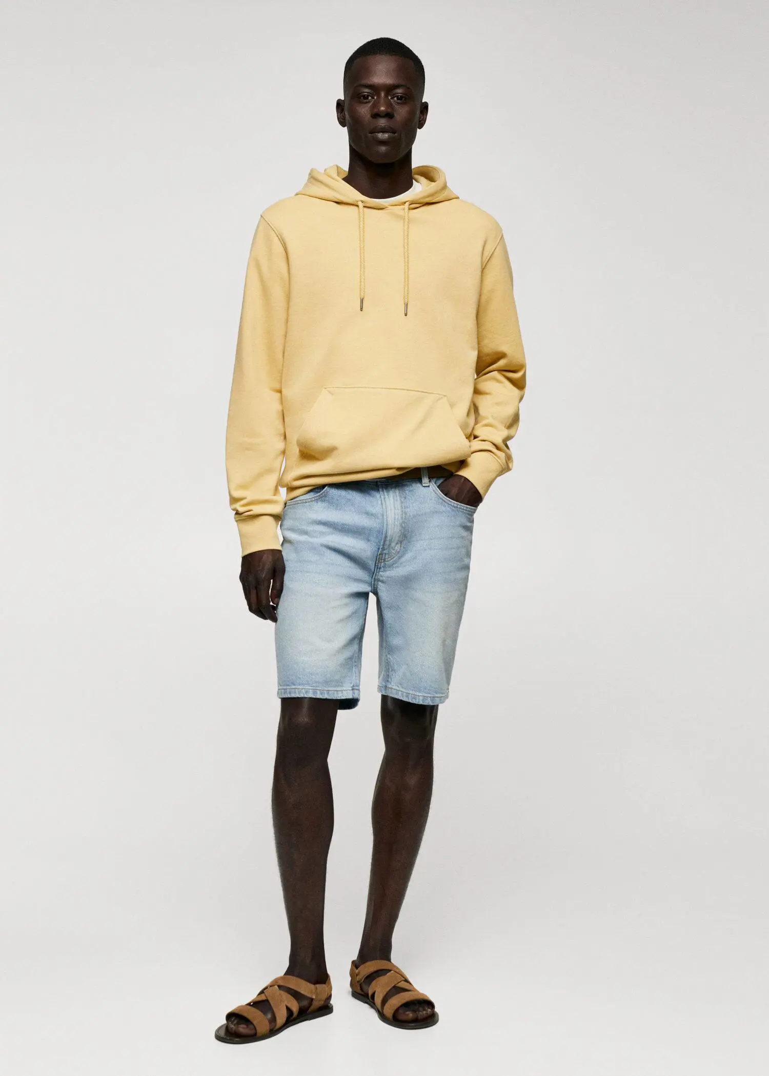Mango Hoodie cotton sweatshirt. a man in a yellow hoodie and blue shorts. 
