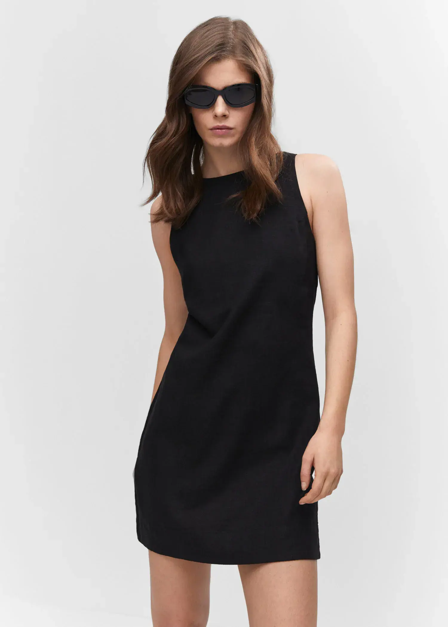 Mango Linen dress with back opening. a woman wearing a black dress and sunglasses. 