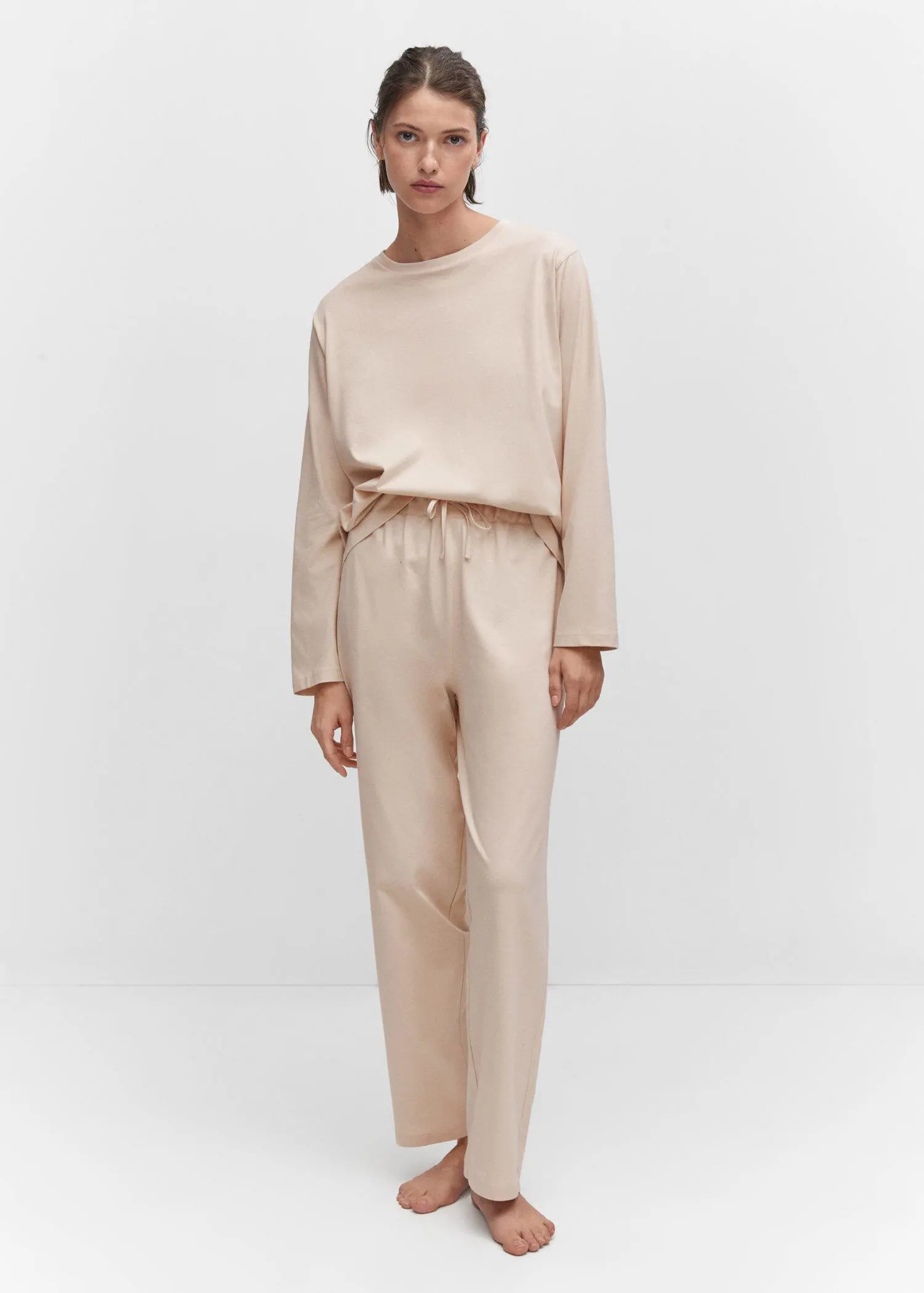 Mango Cotton long pyjamas. a person standing in a room wearing a beige outfit. 
