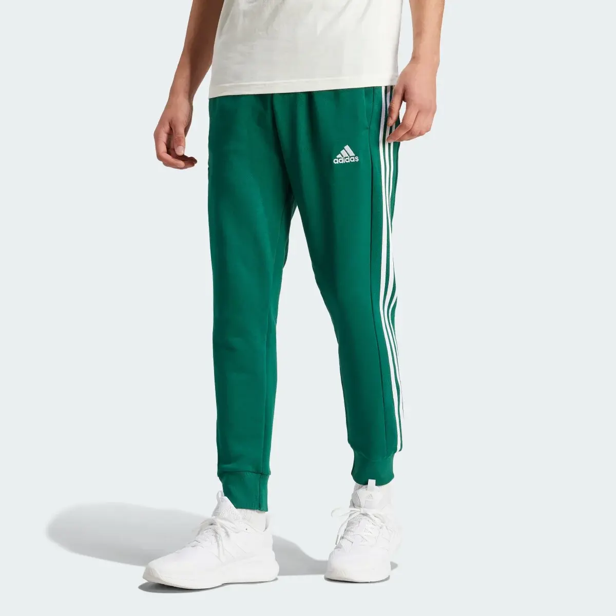 Adidas Essentials French Terry Tapered Cuff 3-Streifen Hose. 1