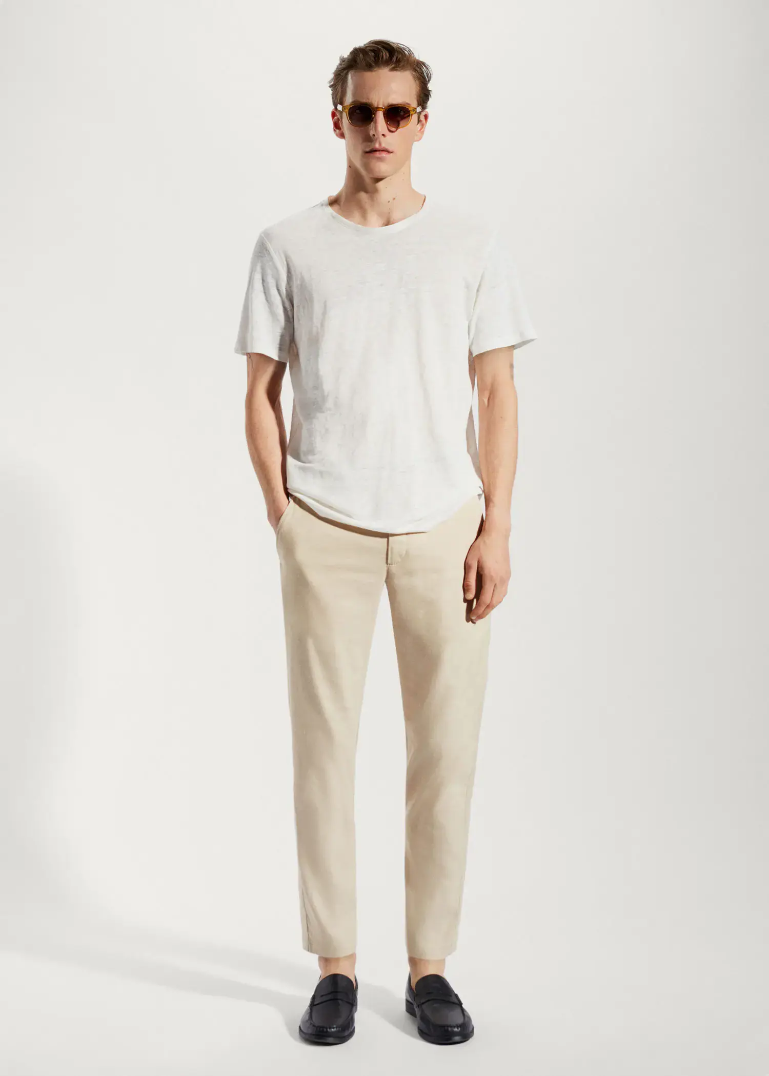 Mango Linen slim-fit pants with inner drawstring. a man in a white t-shirt is standing with his hands in his pockets 
