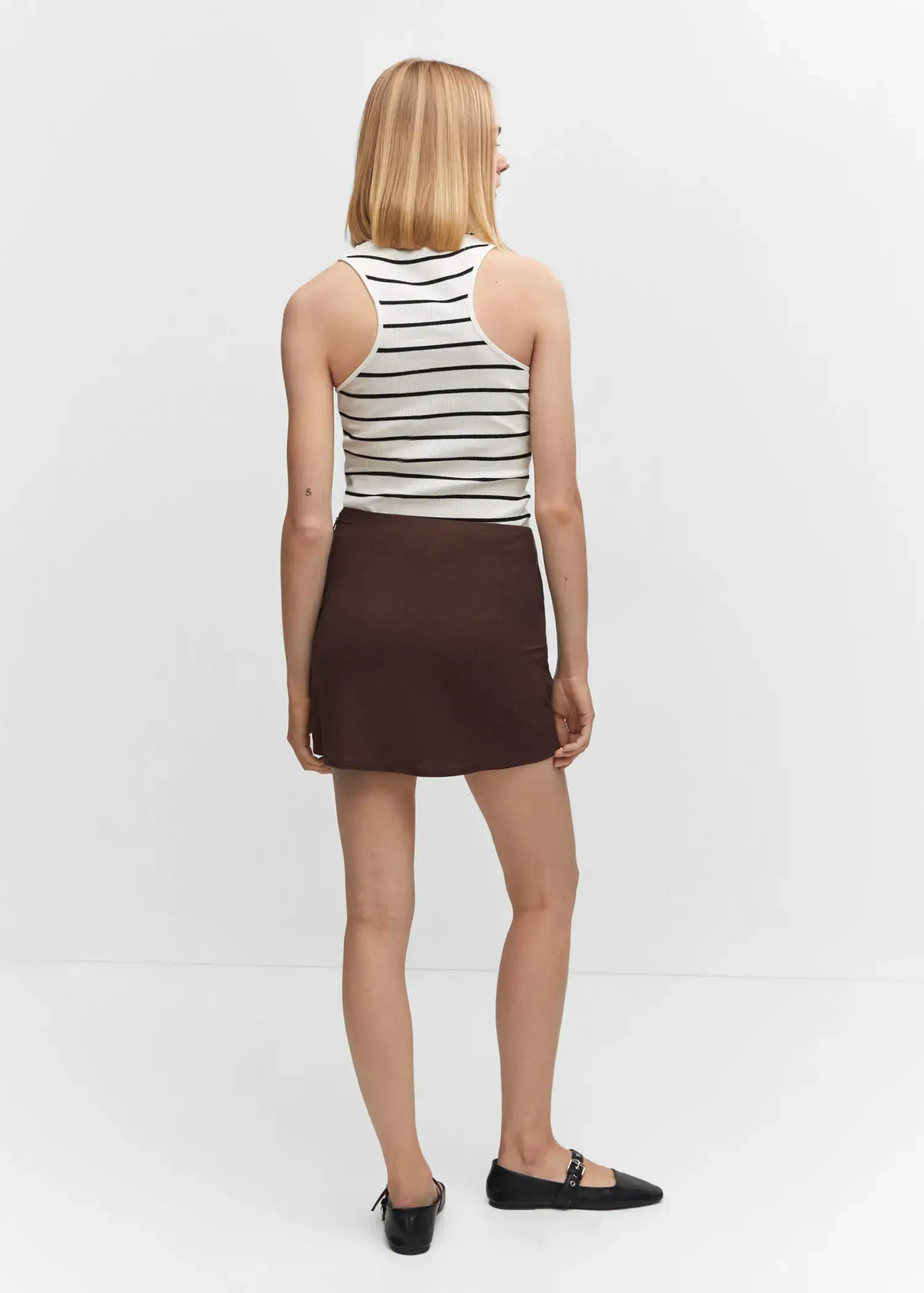 Mango Bow wrap skirt. a woman in a striped tank top and a brown skirt. 