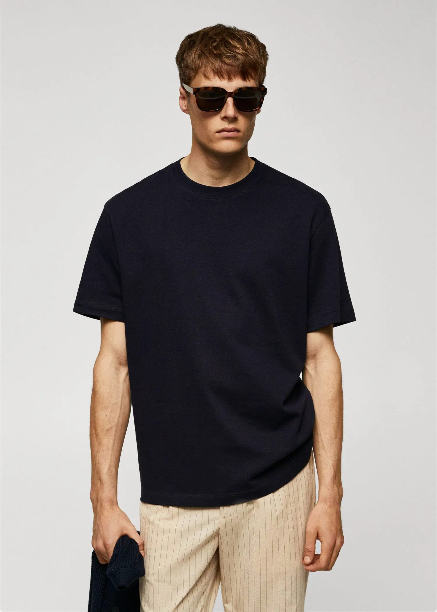 Mango Basic 100% cotton relaxed-fit t-shirt. a man wearing sunglasses and a black t-shirt. 