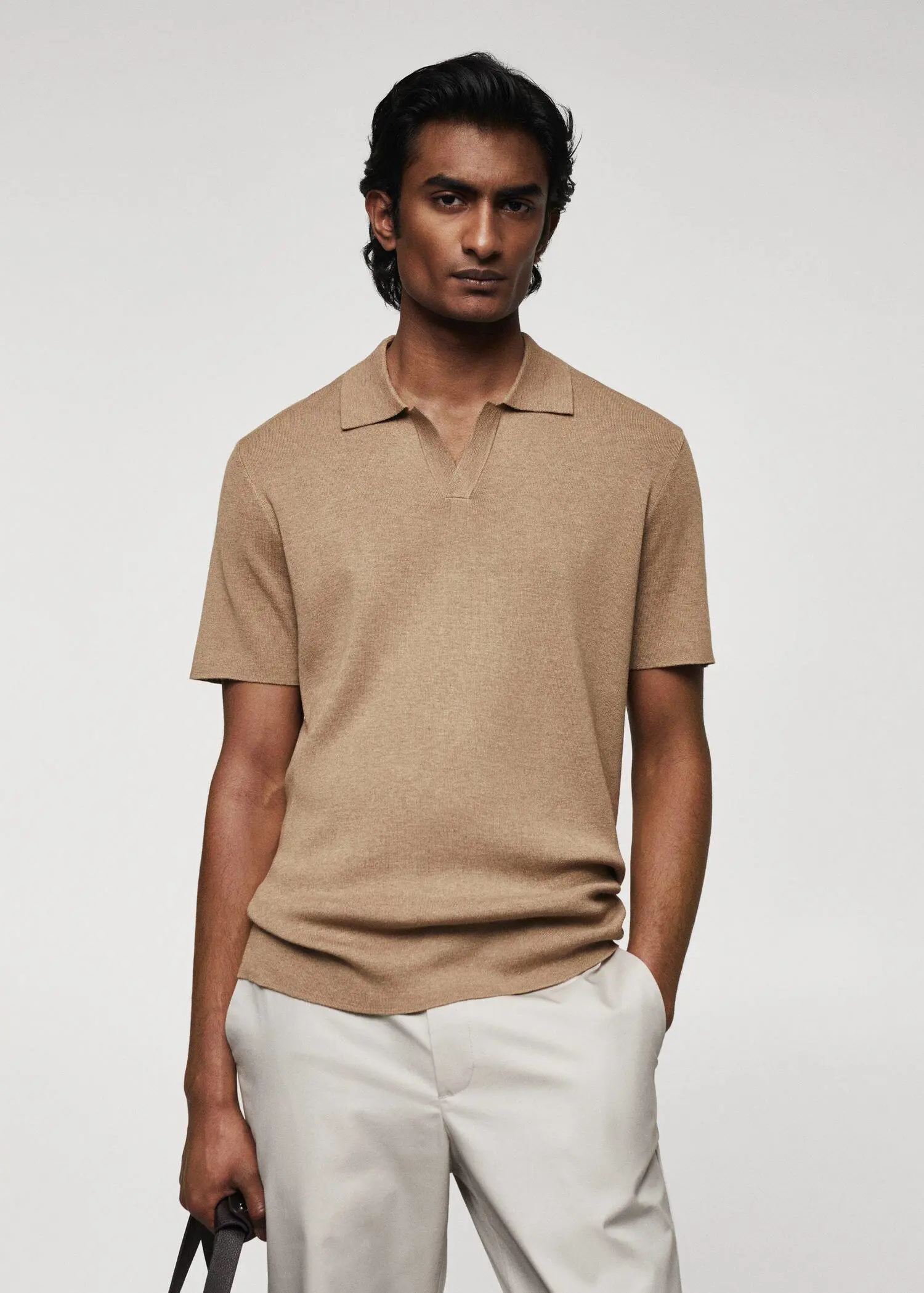 Mango Fine-knit polo shirt. a man in a tan polo shirt and white pants. 