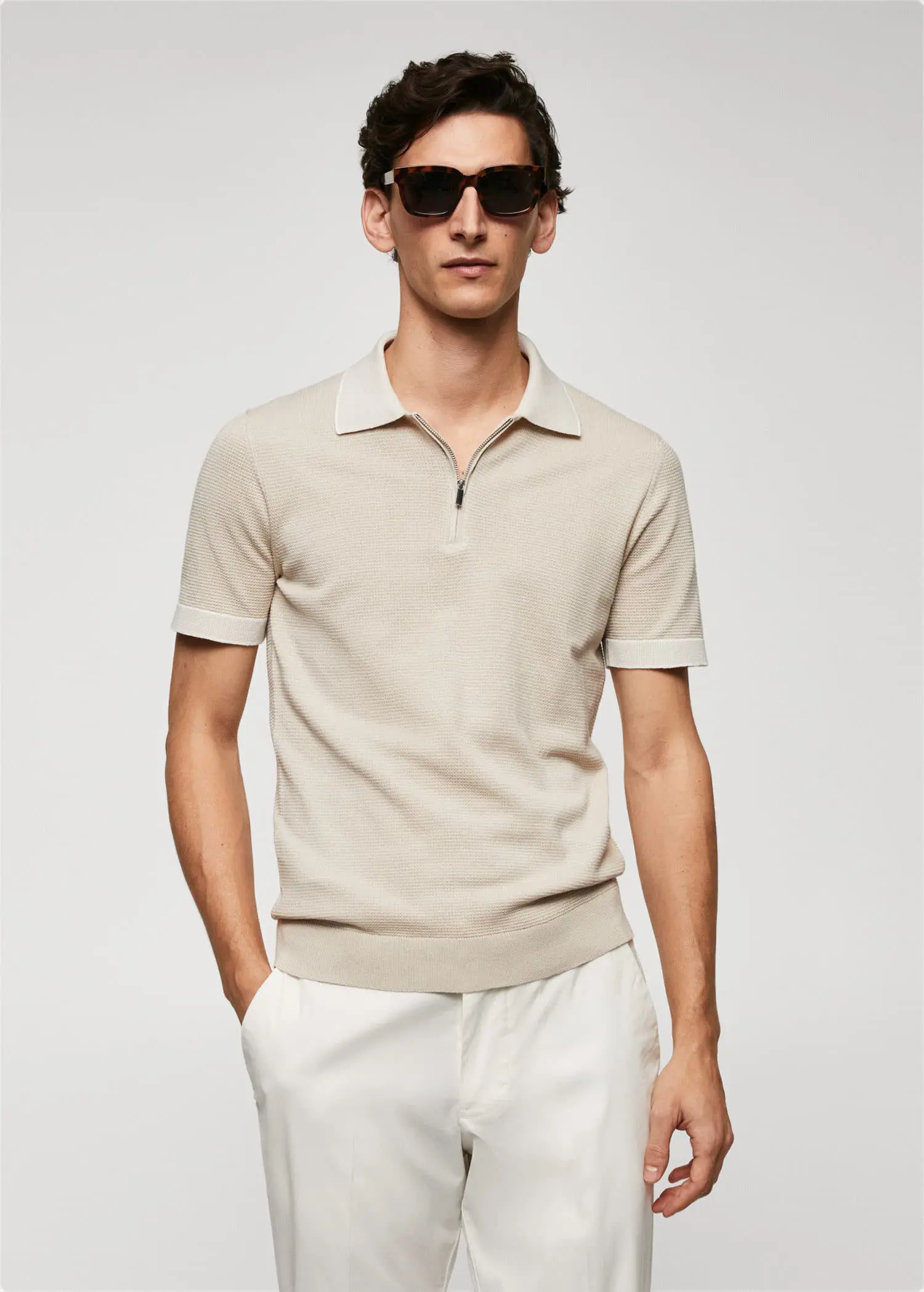 Mango Fine-knit polo shirt with zipper. a man in a tan polo shirt and white pants. 