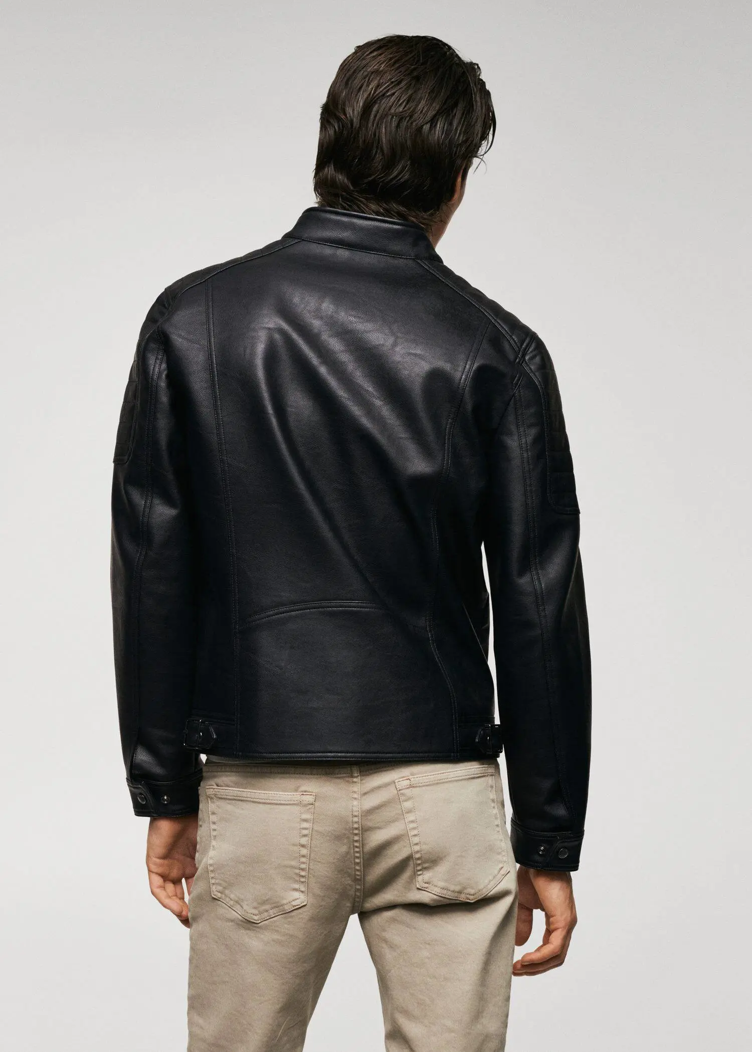 Mango Nappa leather-effect jacket. a man wearing a black leather jacket and beige shorts. 