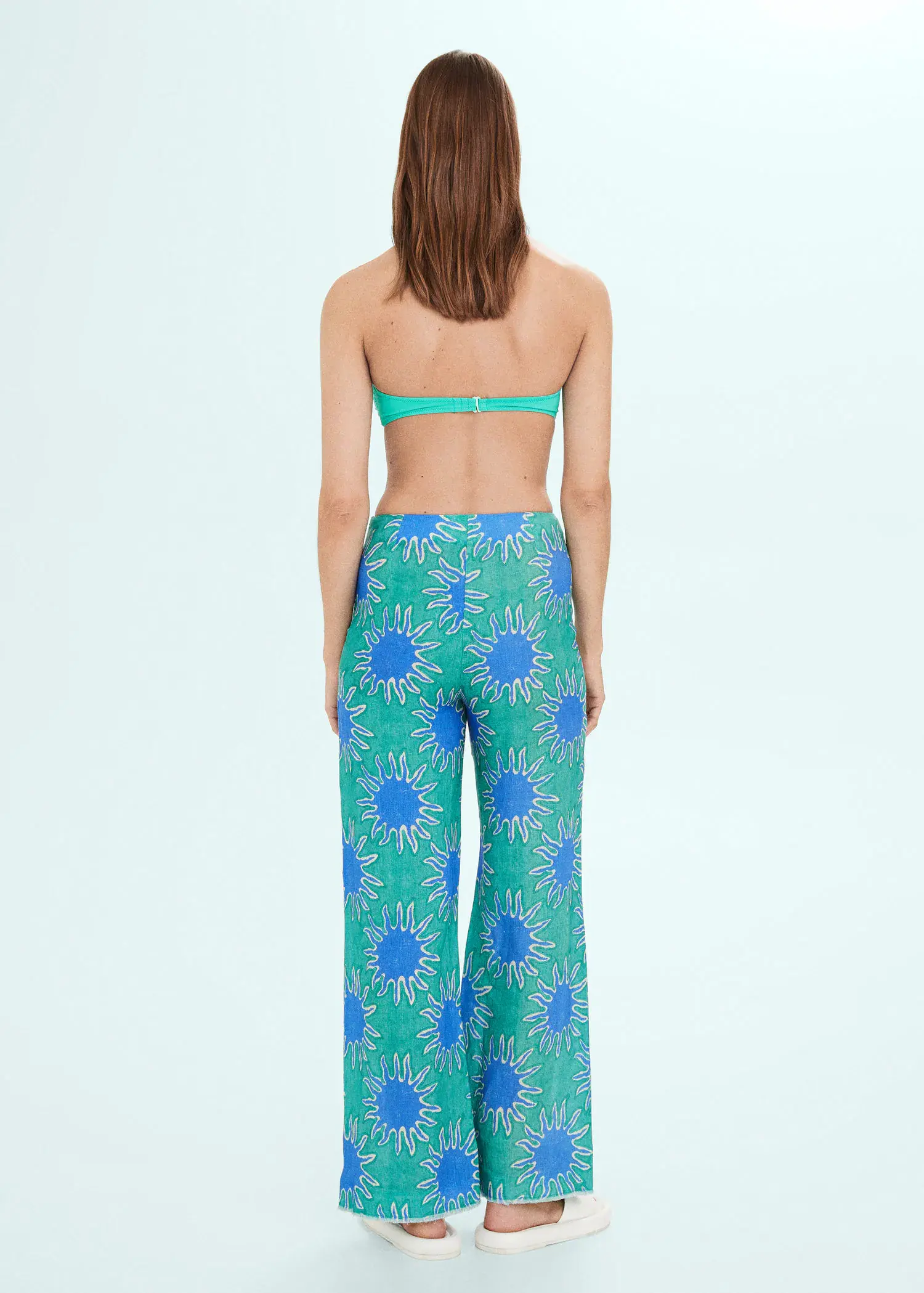 Mango Printed linen wideleg trousers. a woman in a blue and white floral print pants and a bra top. 