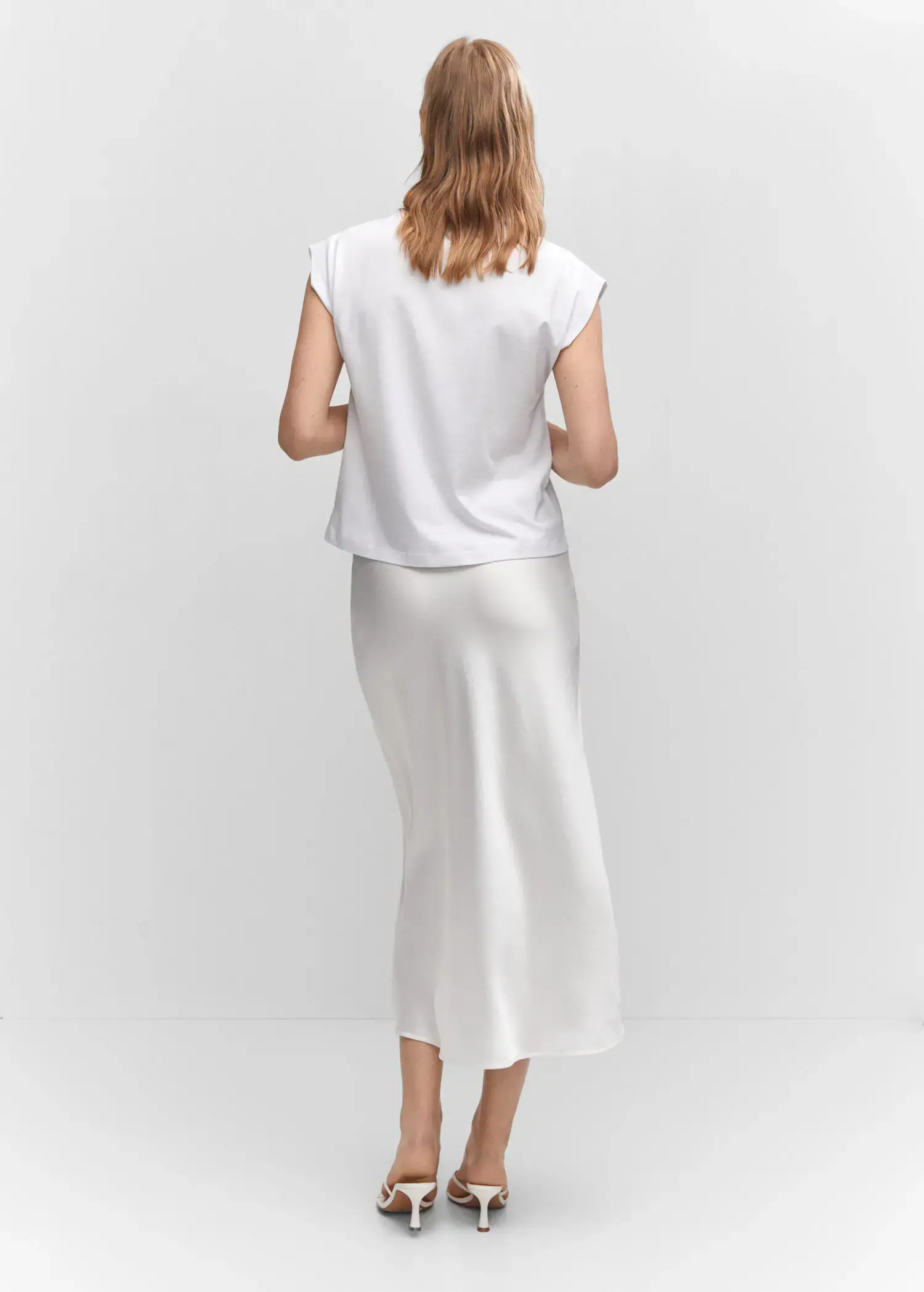 Mango Message cotton T-shirt. a woman in a white dress standing in front of a white wall. 