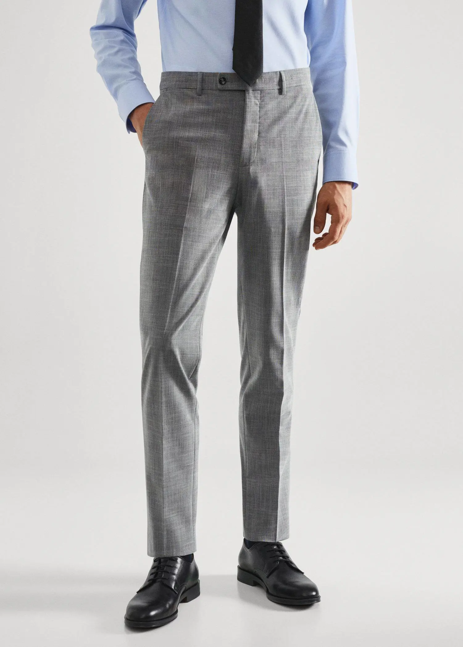 Mango Stretch fabric slim-fit printed suit trousers. a man wearing a suit standing in front of a white wall. 