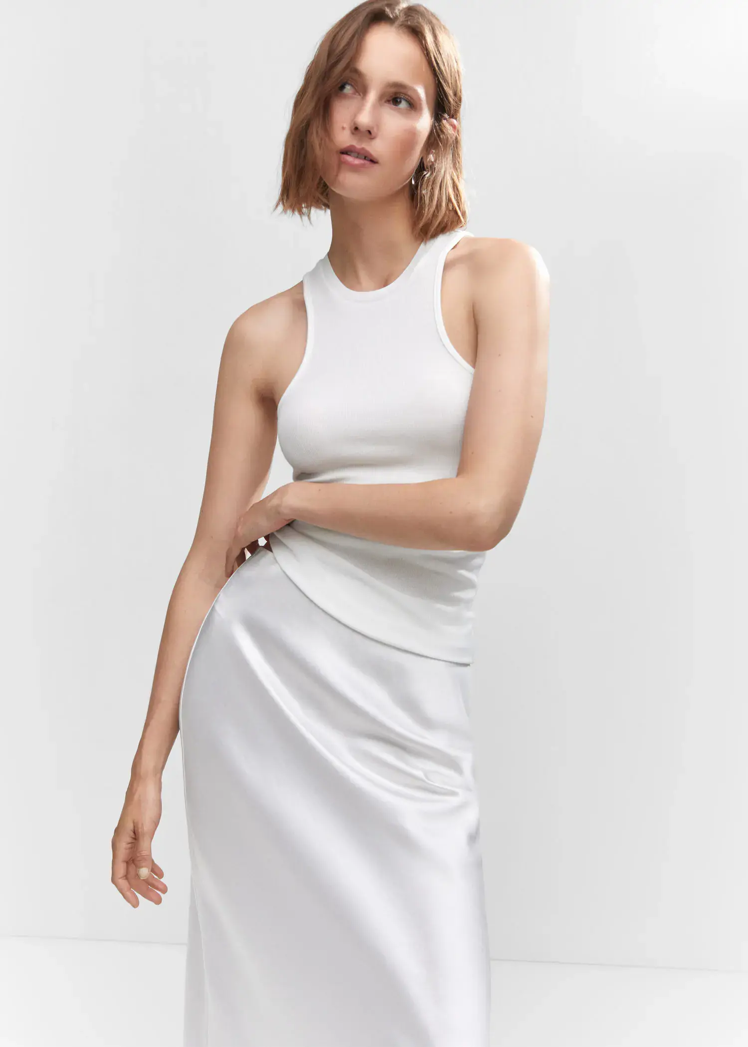 Mango Ribbed strap top. a woman wearing a white dress posing for a picture. 