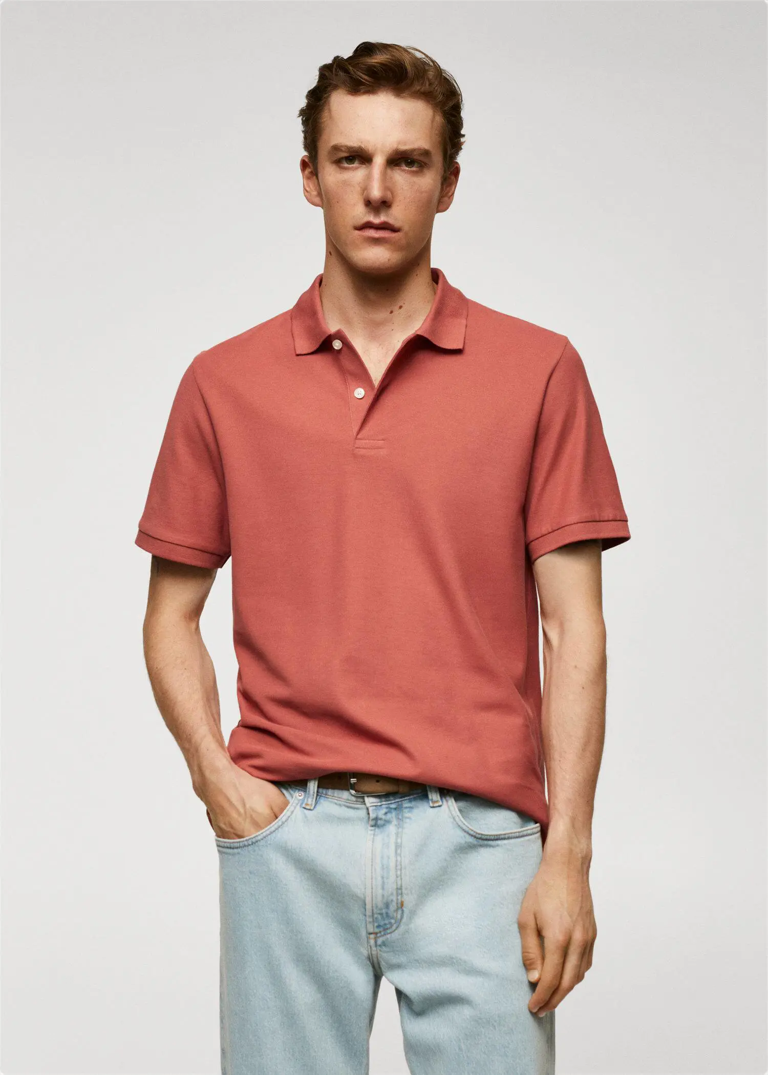 Mango 100% cotton pique polo shirt. a man wearing a red polo shirt and blue jeans. 
