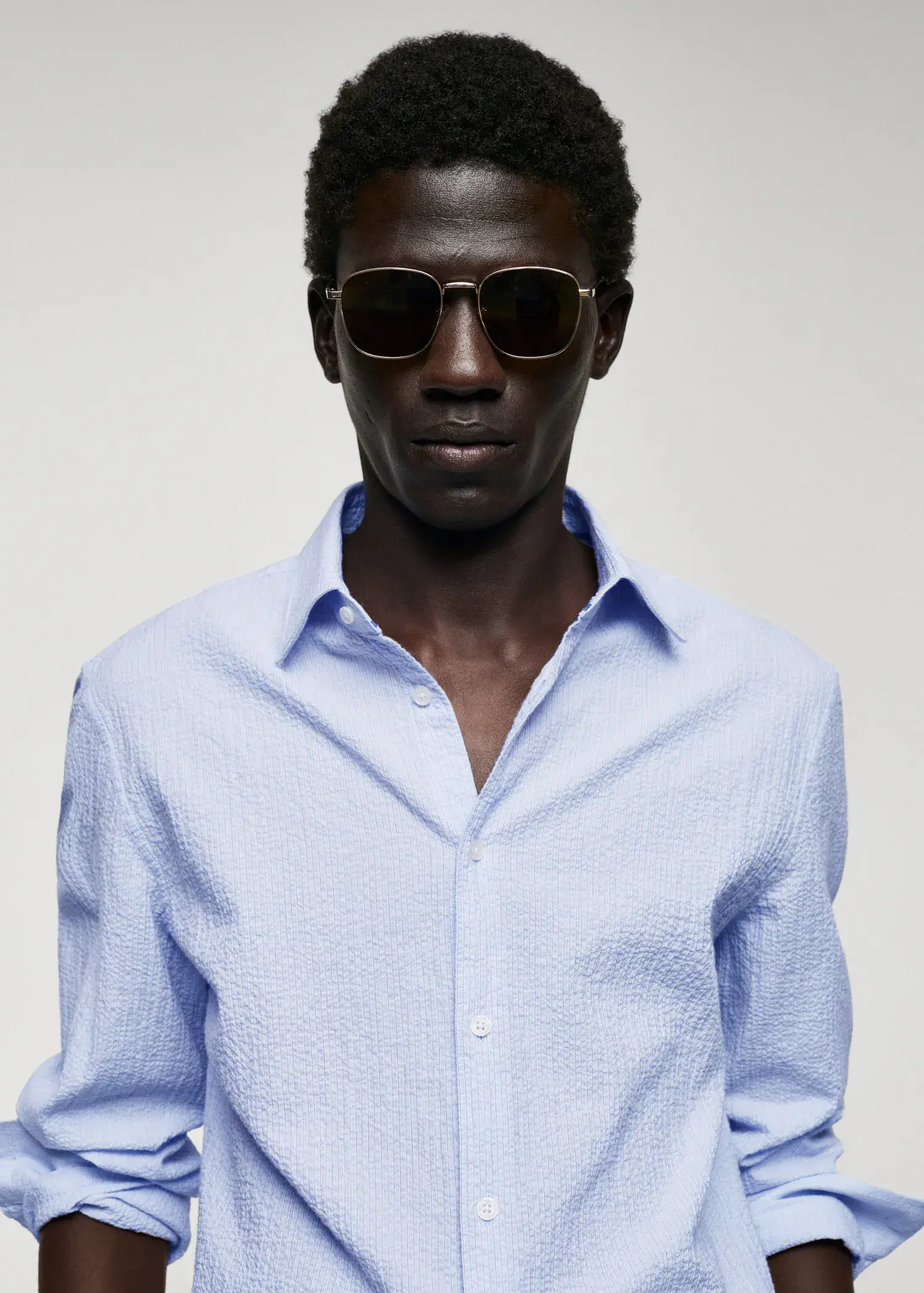 Mango Cotton seersucker shirt with multiple stripes. a man wearing a blue shirt and sunglasses. 