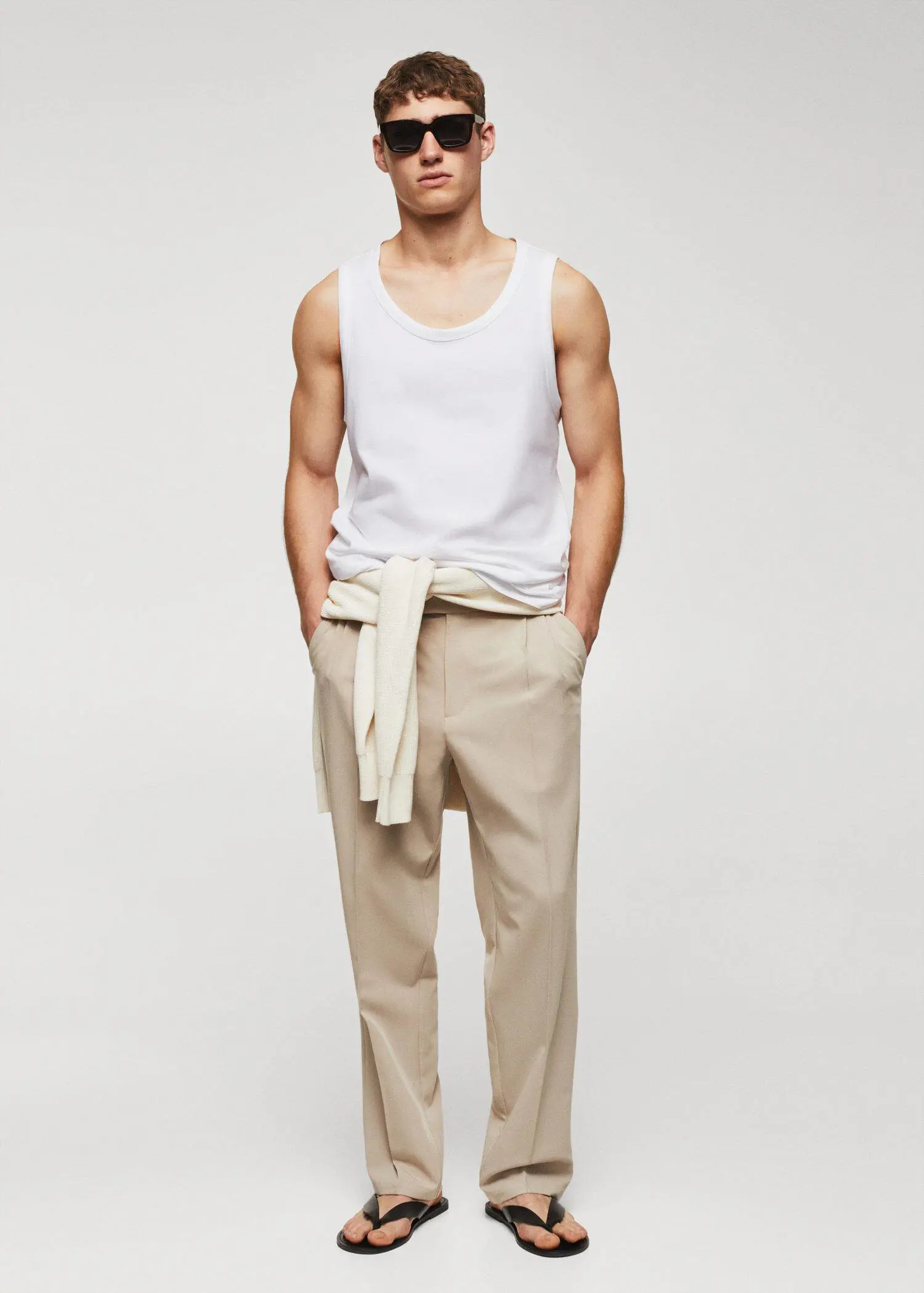 Mango Strap cotton T-shirt. a man in a white tank top and beige pants. 