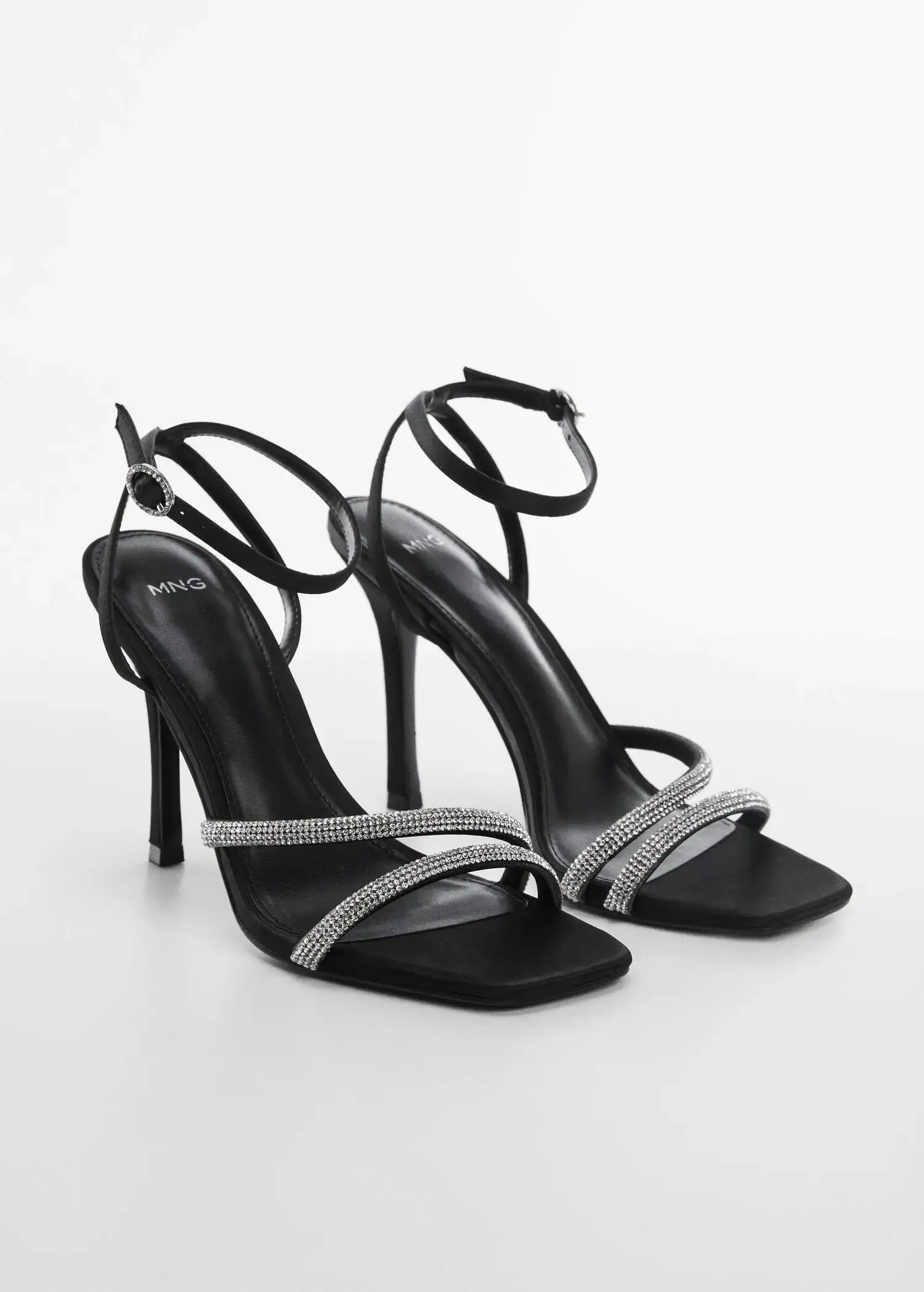 Mango Heeled sandals with rhinestone straps. a pair of high heeled shoes on a white surface. 