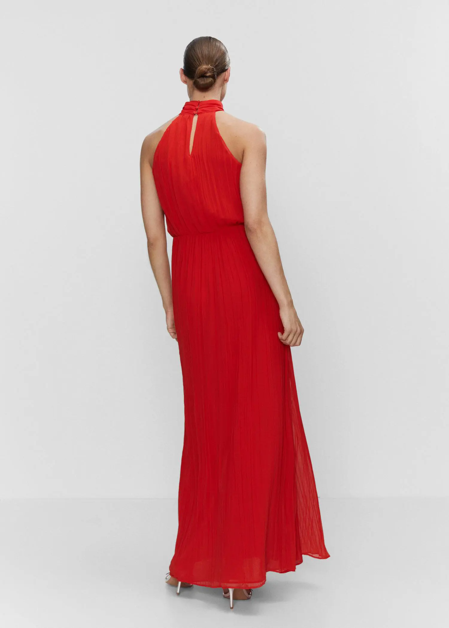 Mango Pleated halter neck dress. a woman wearing a red dress standing in a room. 