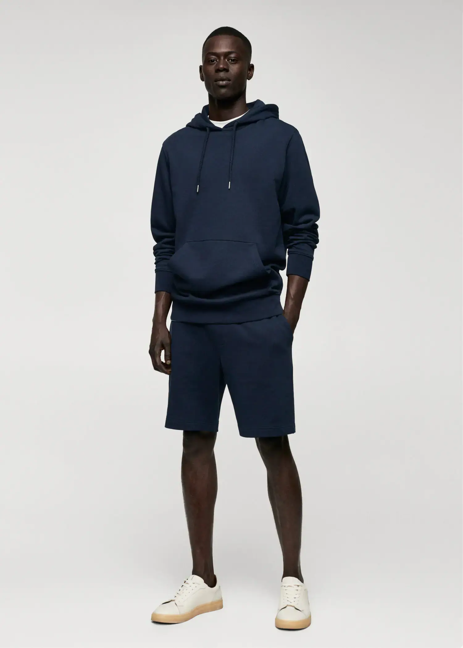 Mango Jogger cotton Bermuda shorts. a man wearing a blue hoodie and shorts. 