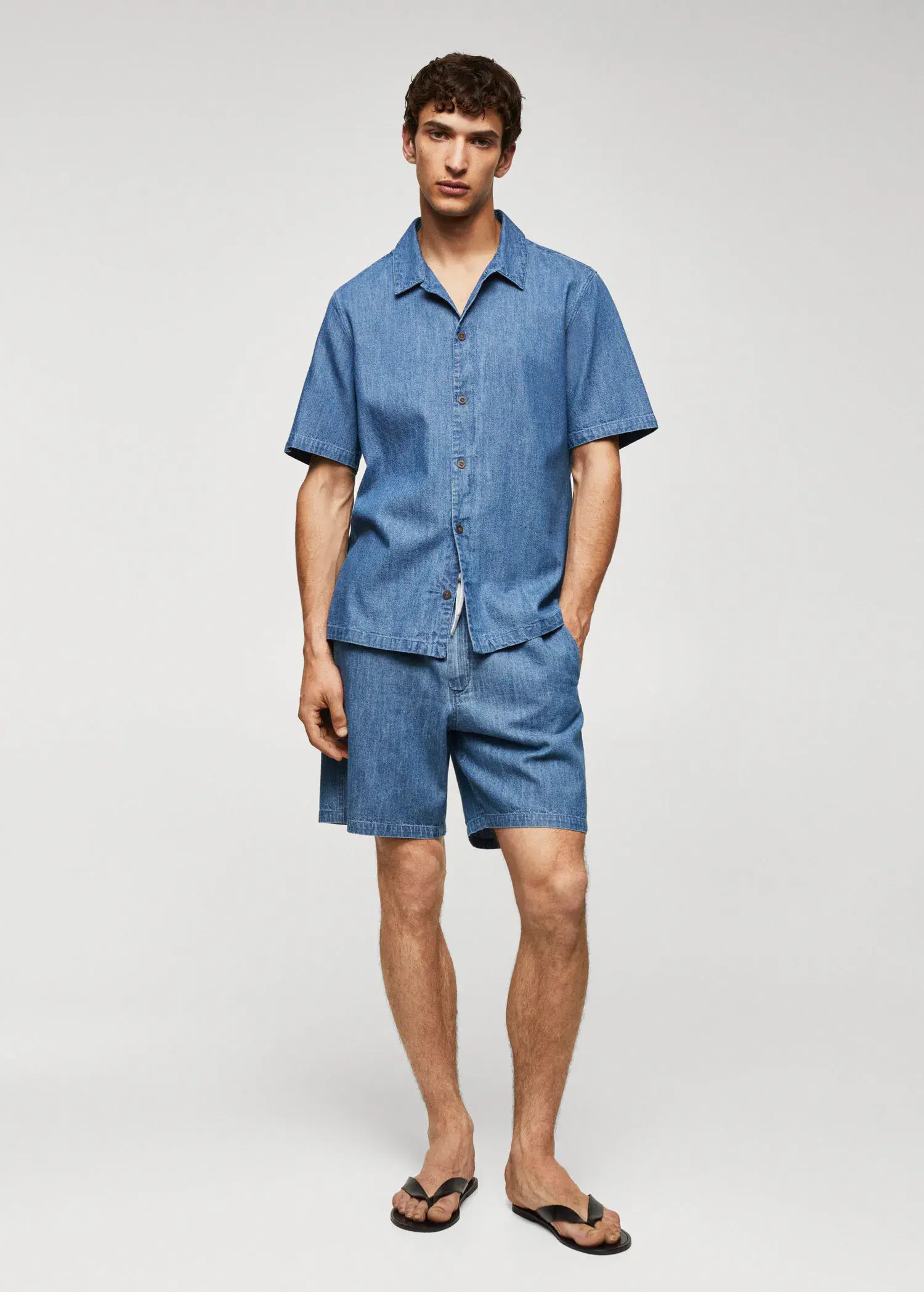 Mango 100% cotton chambray shirt. a man wearing a blue shirt and shorts. 