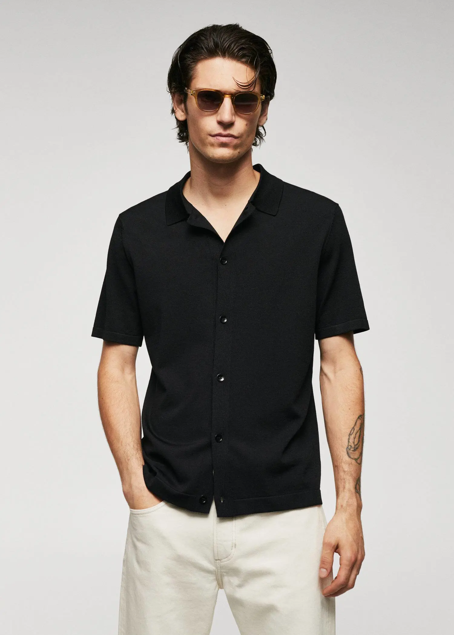 Mango Fine-knit buttoned polo shirt. a man wearing a black shirt and sunglasses. 