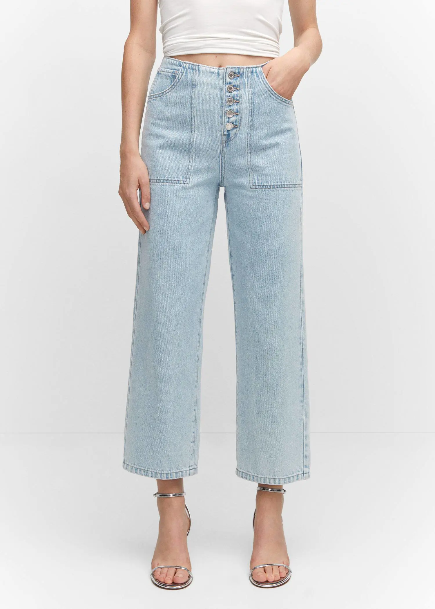 Mango Cropped straight-leg jeans with buttons. a person wearing a pair of light blue jeans. 