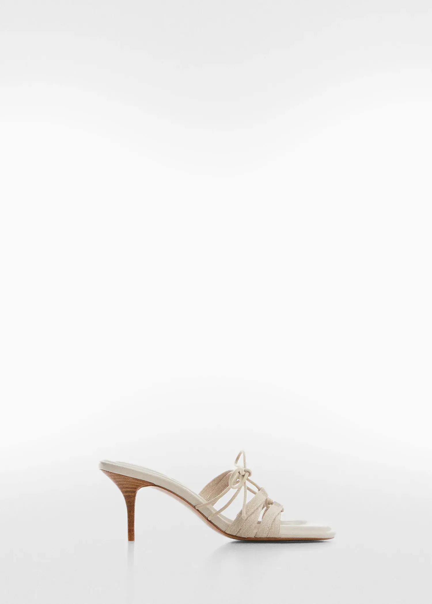 Mango Bow heel sandals. a pair of white high heeled shoes on a white background 