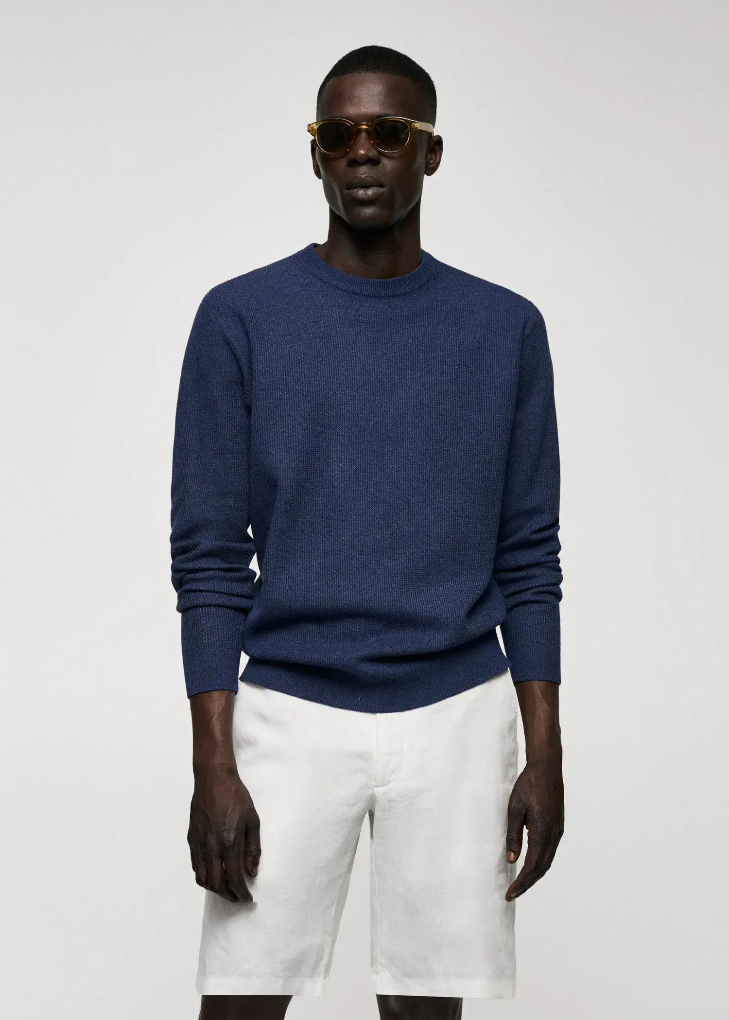 Mango Structured cotton sweater. a man wearing a blue sweater and white pants. 