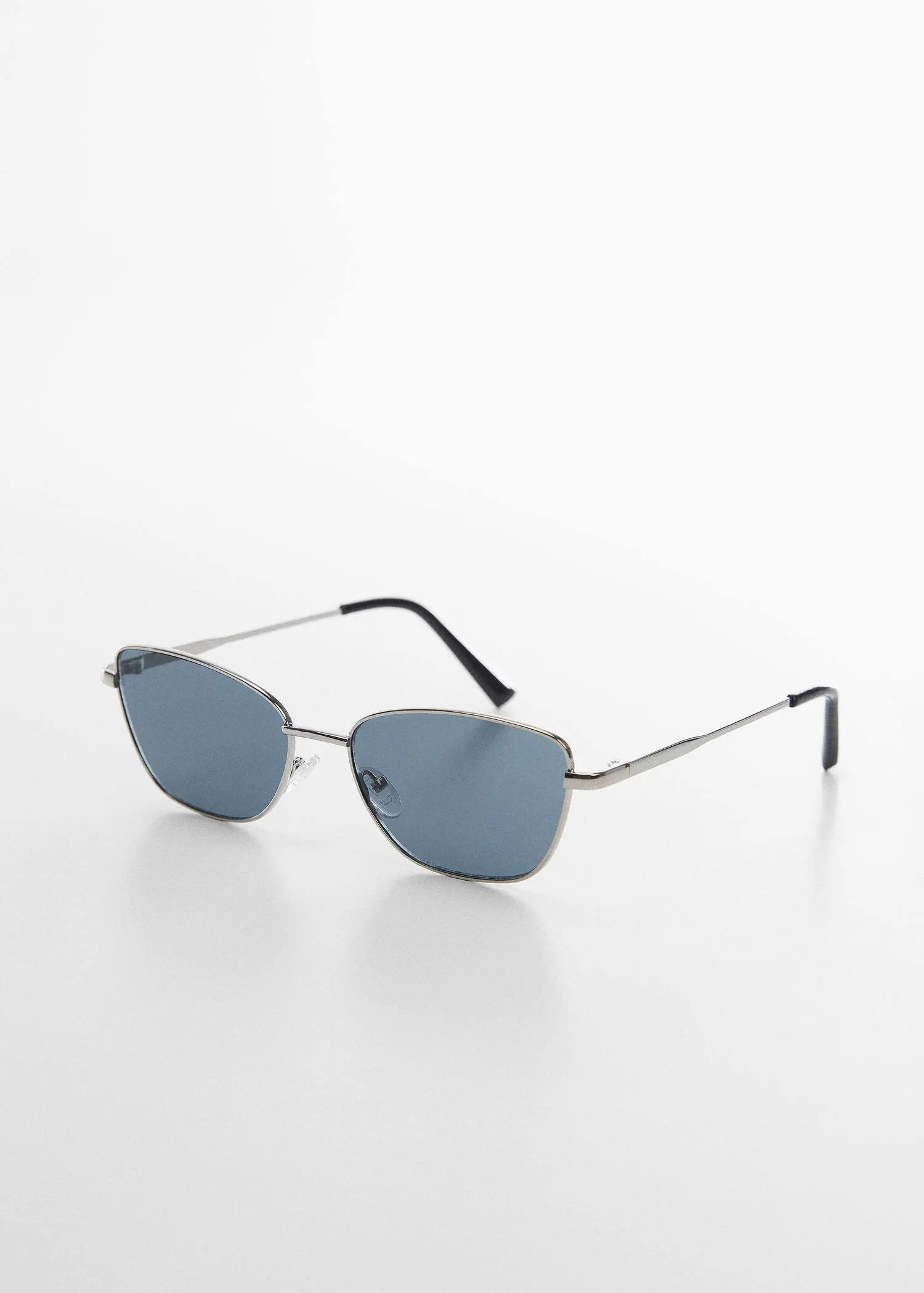 Mango Metal bridge sunglasses. a pair of sunglasses on a white surface. 