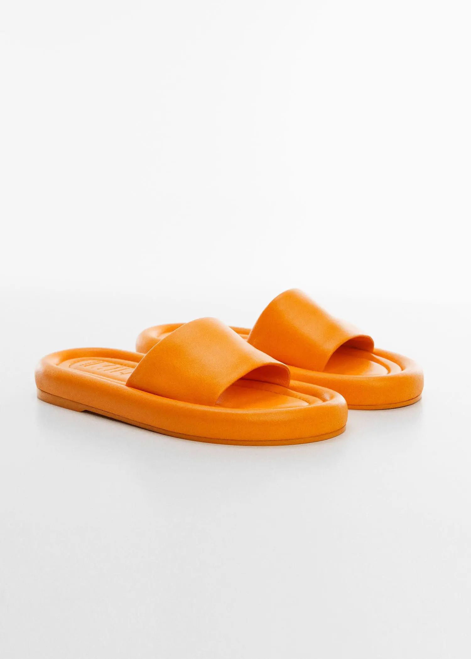 Mango Leather thong sandals. a pair of orange sandals sitting on top of a table. 