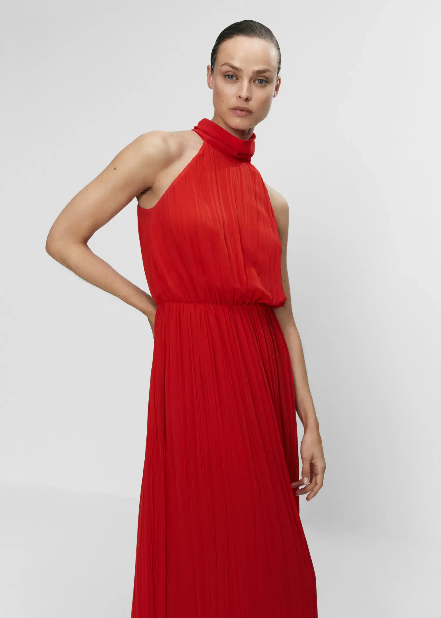 Mango Pleated halter neck dress. a woman in a red dress posing for a picture. 