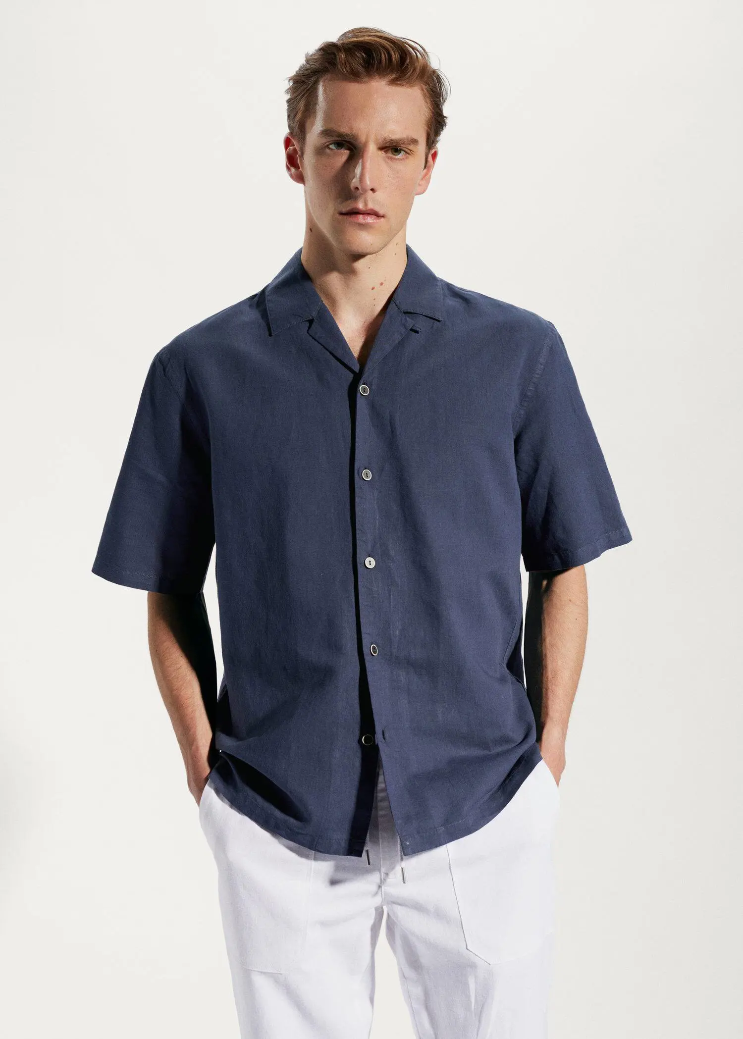 Mango Cotton-linen bowling-collar shirt. a man in a blue shirt is posing for a picture. 