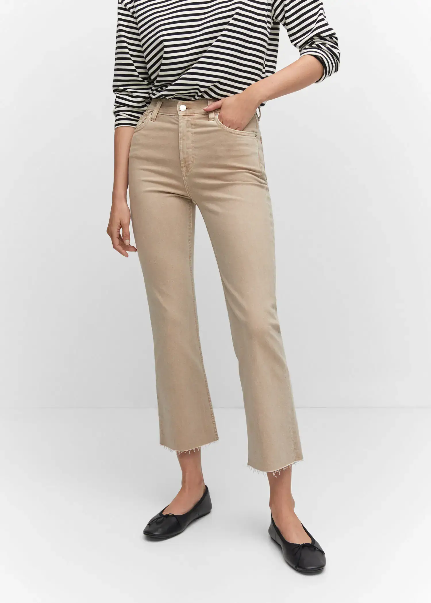 Mango Crop flared jeans. a woman wearing a pair of beige pants. 