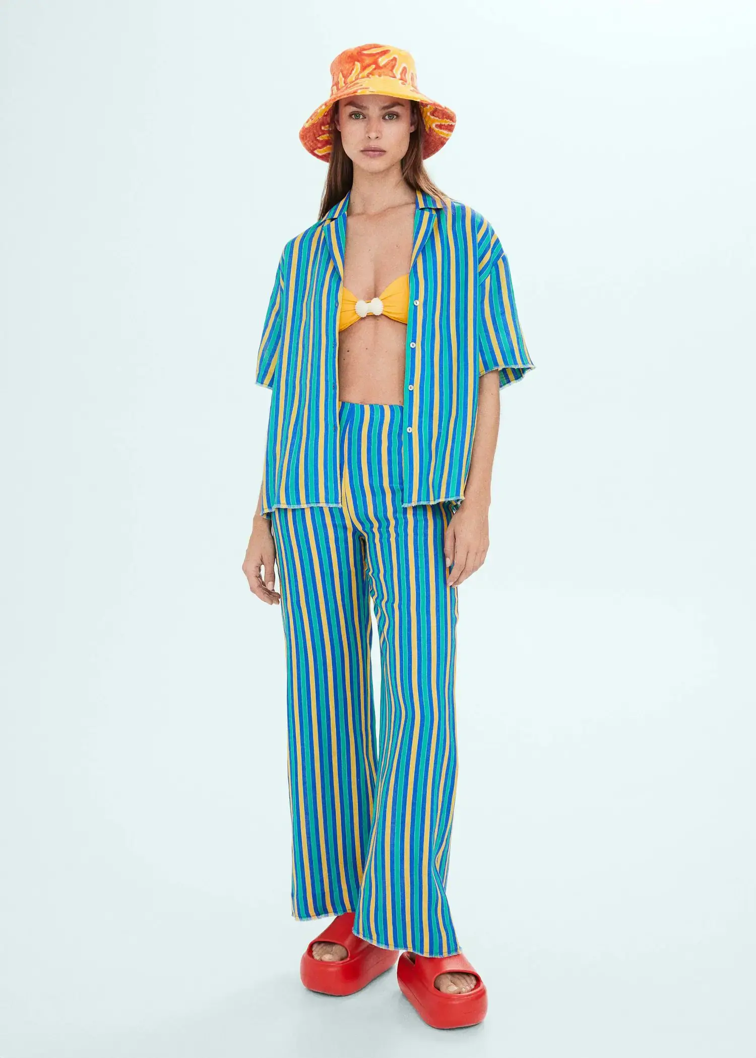 Mango Multi-colored striped linen shirt. a woman in a blue and white striped outfit. 