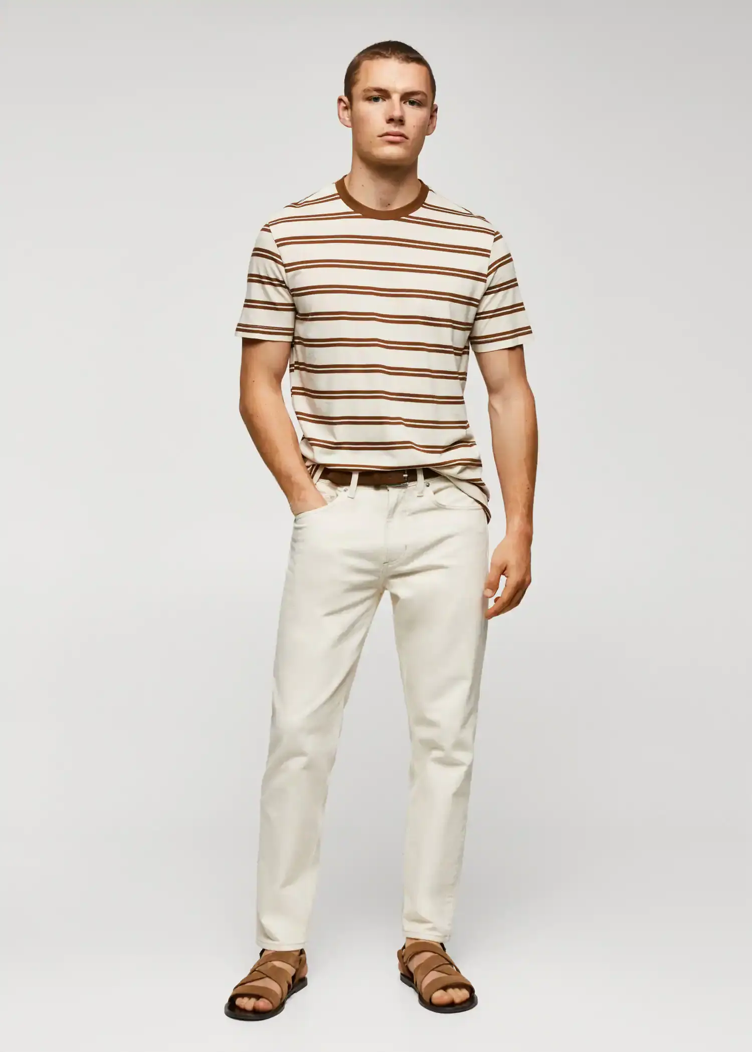 Mango Cotton-modal striped t-shirt. a man wearing a striped shirt and white pants. 