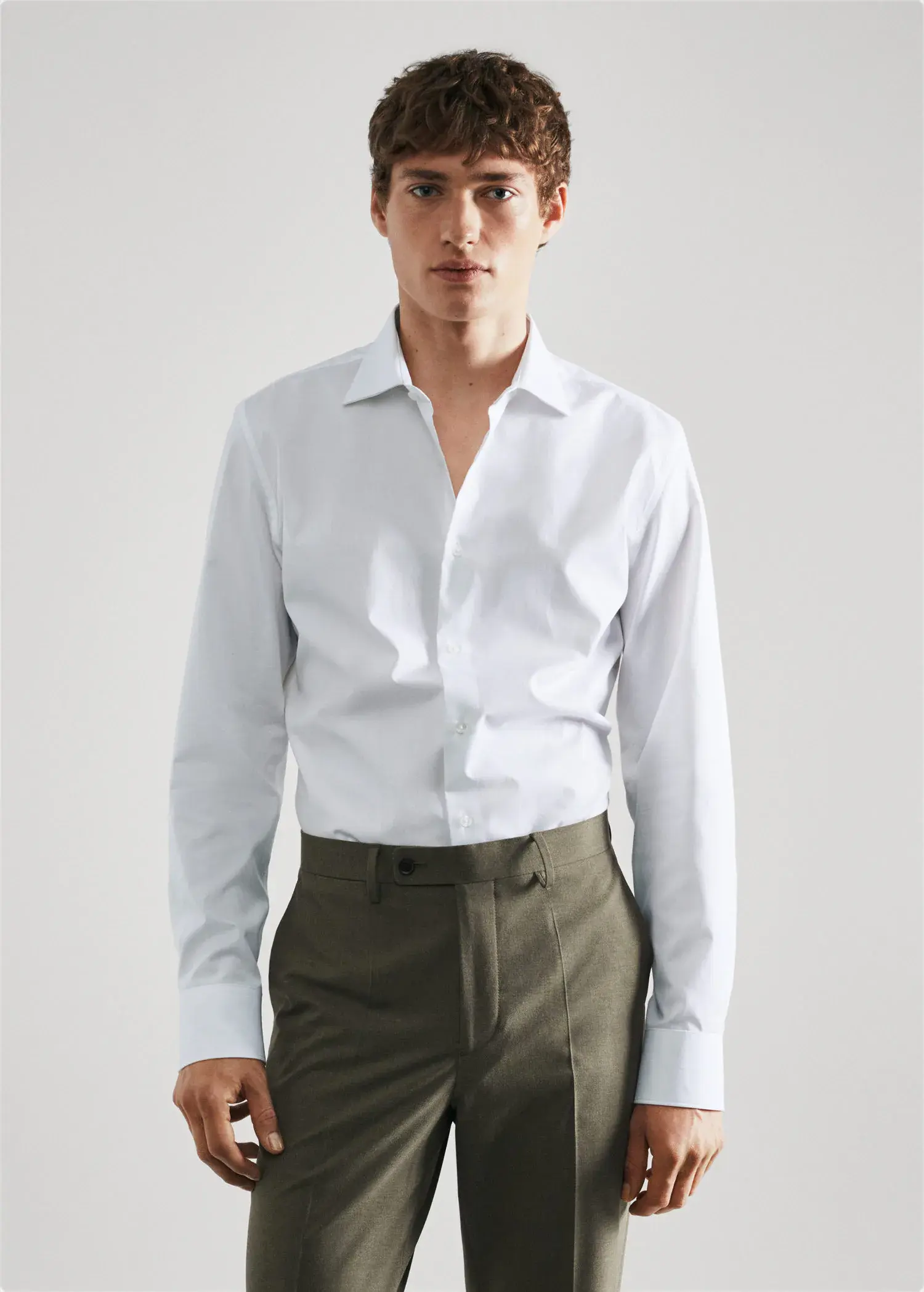 Mango Slim-fit cotton poplin suit shirt. a man wearing a white shirt and brown pants. 