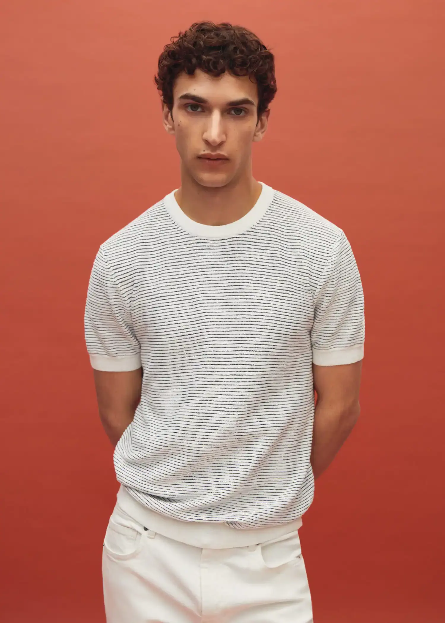 Mango Textured striped T-shirt. a young man wearing a white shirt and white pants. 