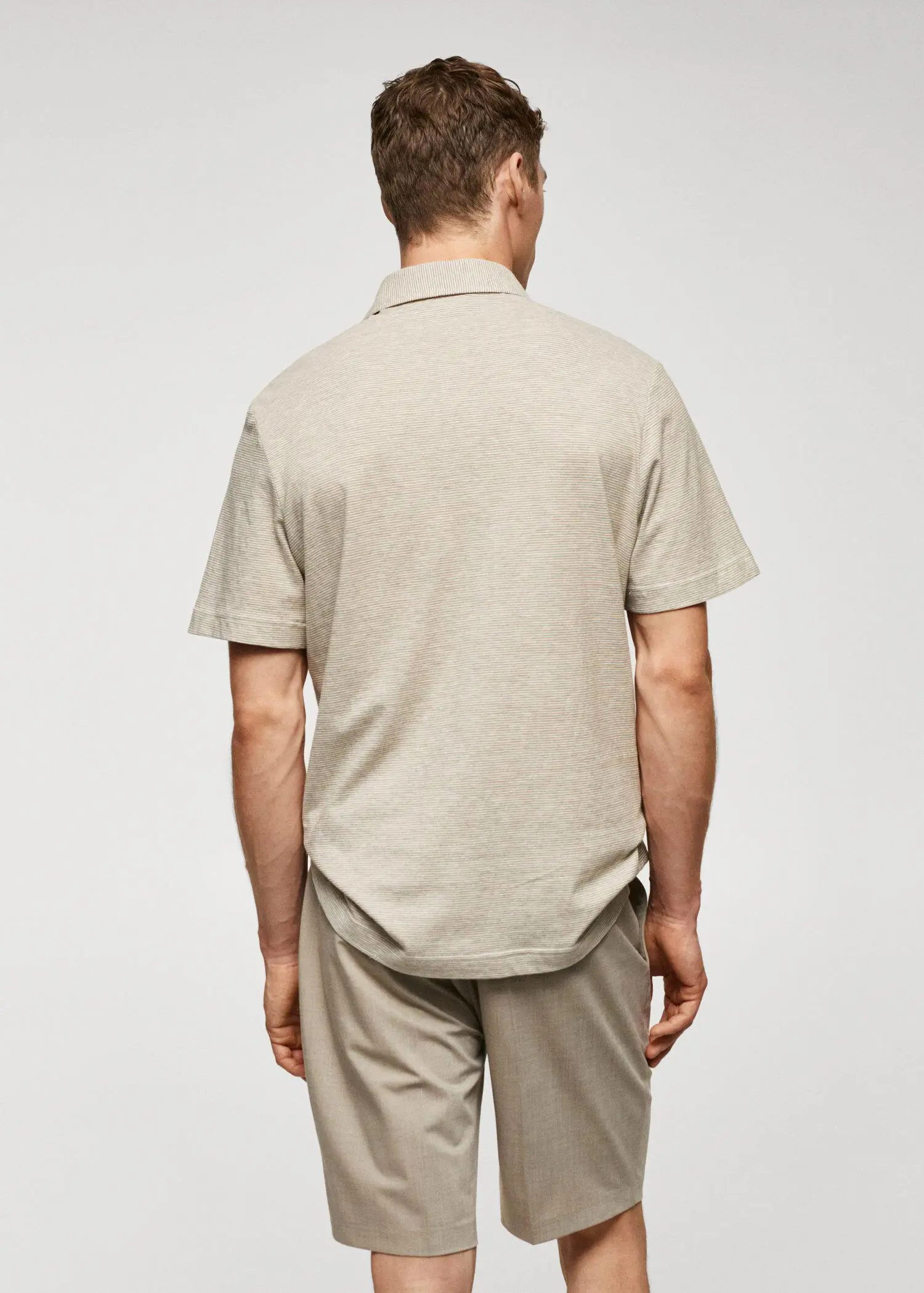 Mango 100% cotton polo shirt with striped structure. a man wearing a tan shirt and khaki pants. 
