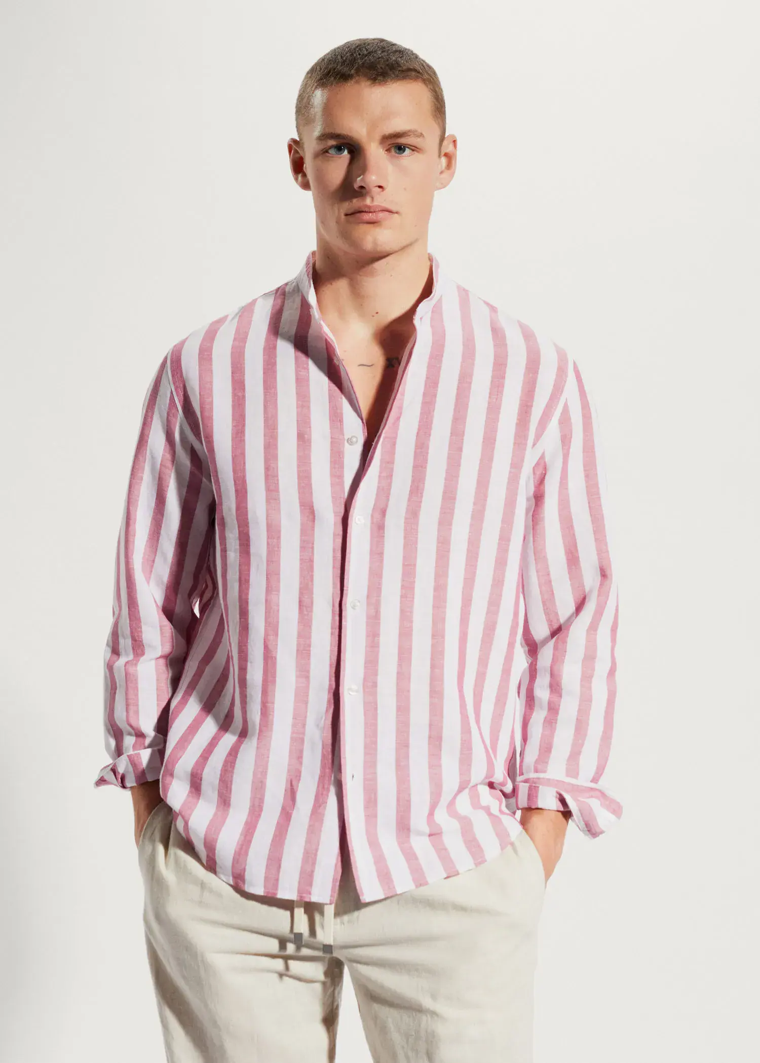 Mango Regular-fit striped linen shirt. a man wearing a pink and white striped shirt. 