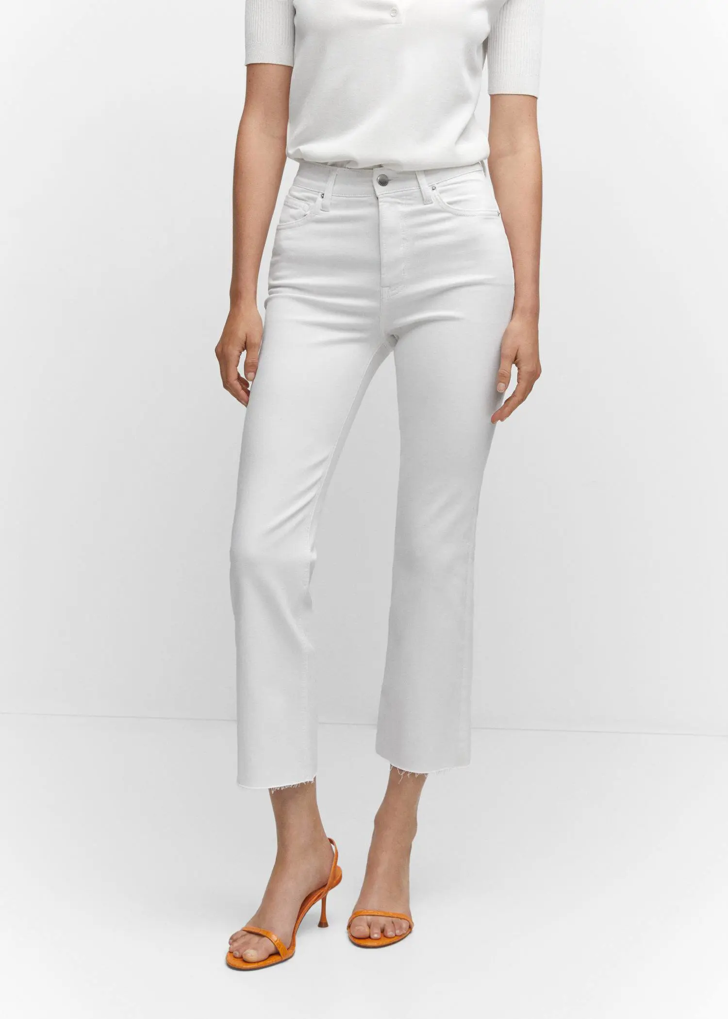 Mango Crop flared jeans. a person wearing white pants and a white shirt. 