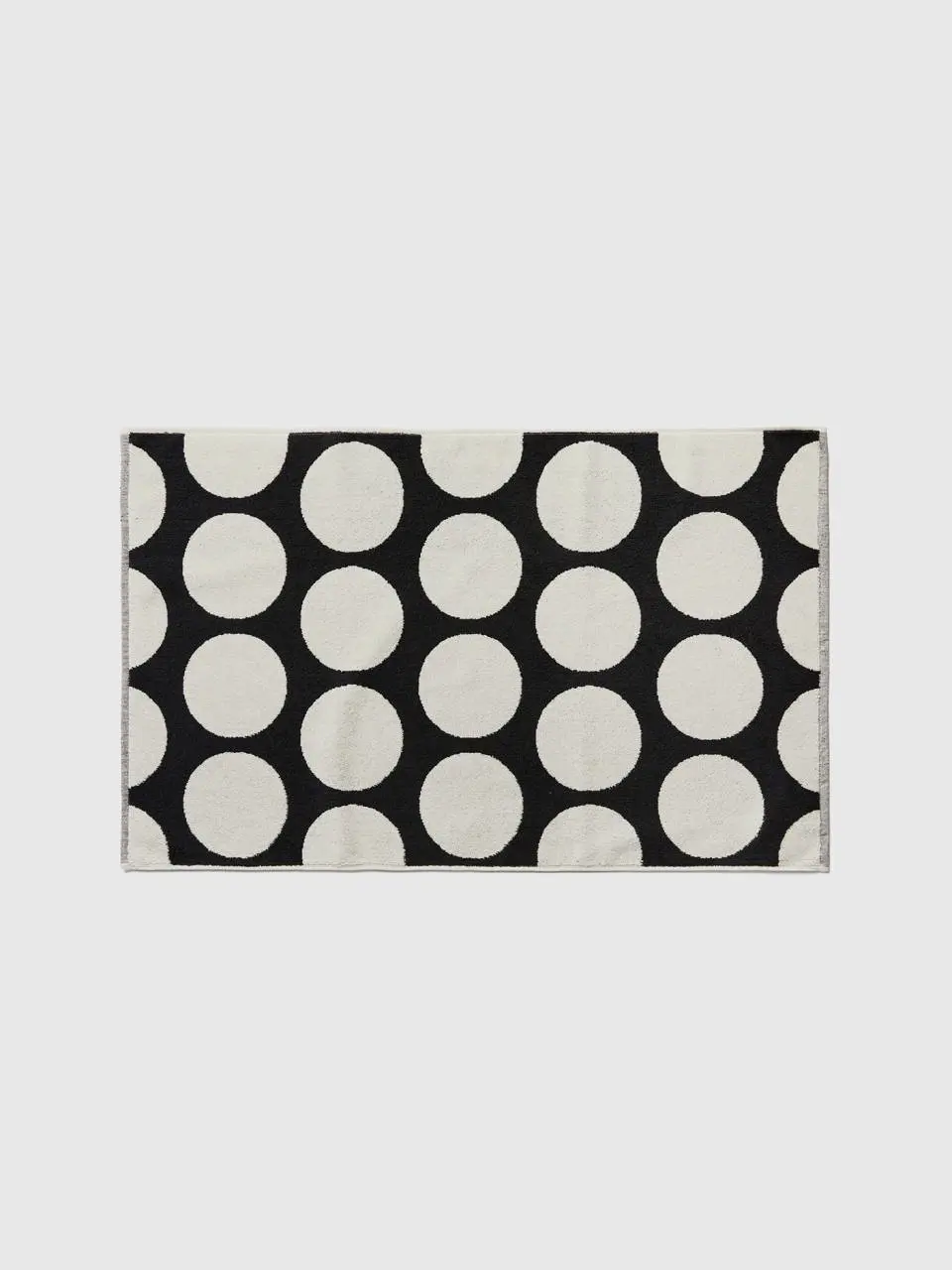 Benetton black bathroom rug with white polka dots. 1