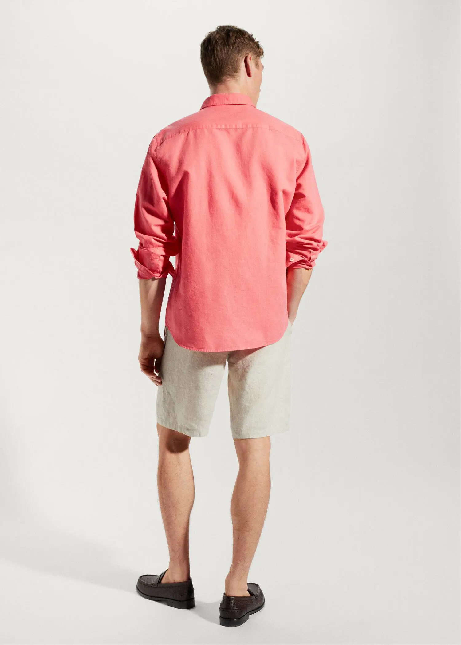 Mango Regular-fit linen cotton shirt. a man wearing a pink shirt and white shorts. 