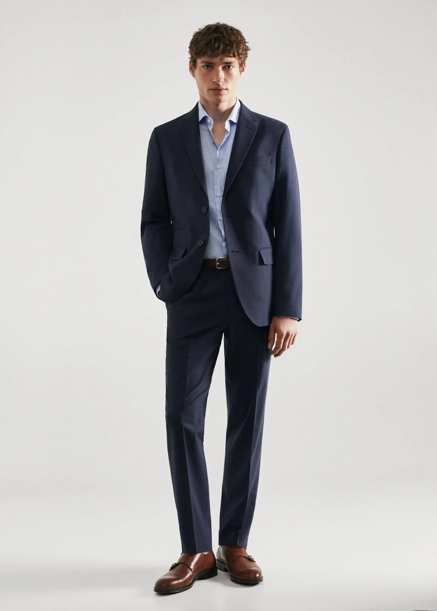 Mango Slim-fit twill pinstripe suit shirt. a man in a suit standing in front of a white wall. 