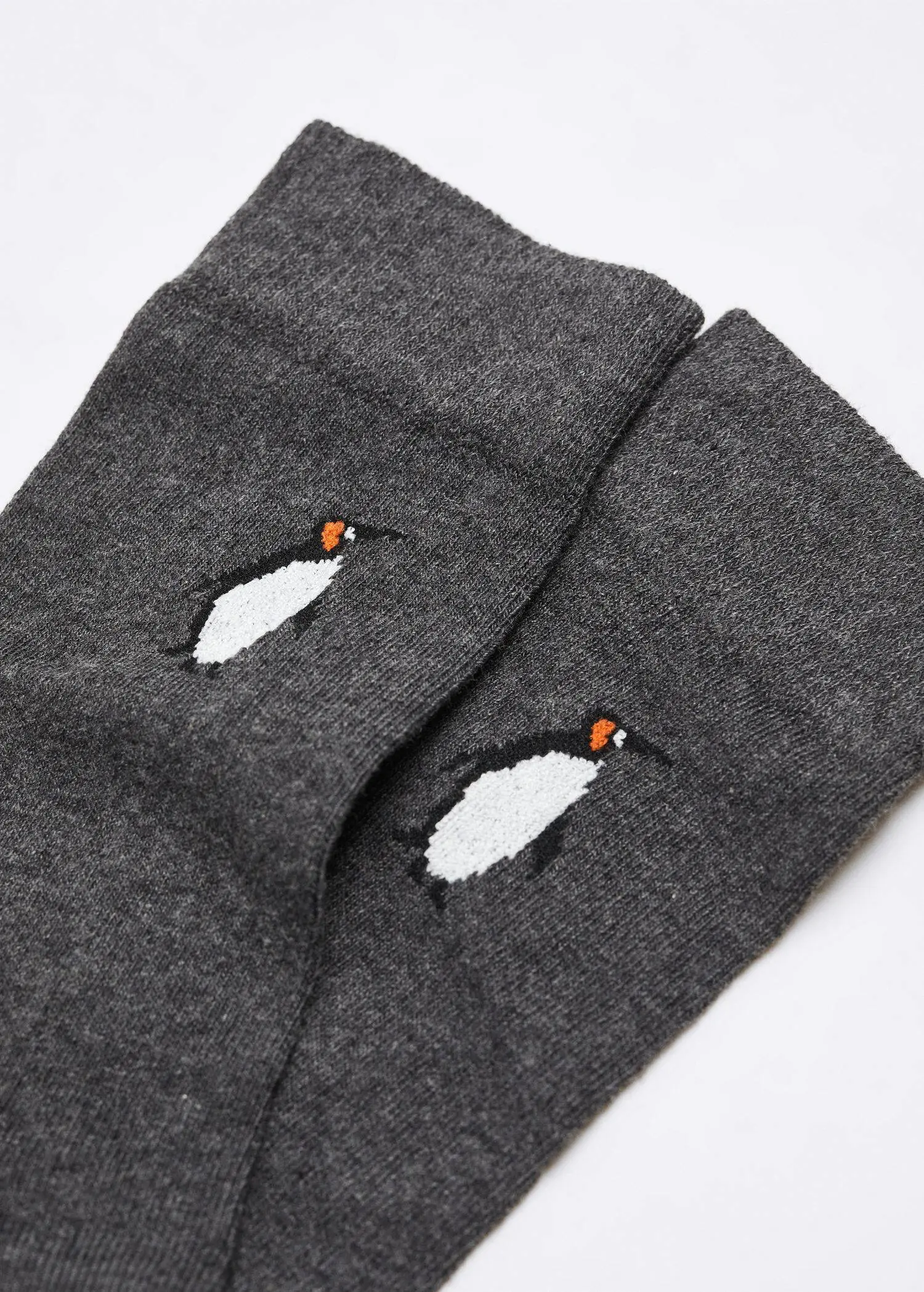Mango Penguin-design cotton socks. a close up of a pair of penguin socks. 