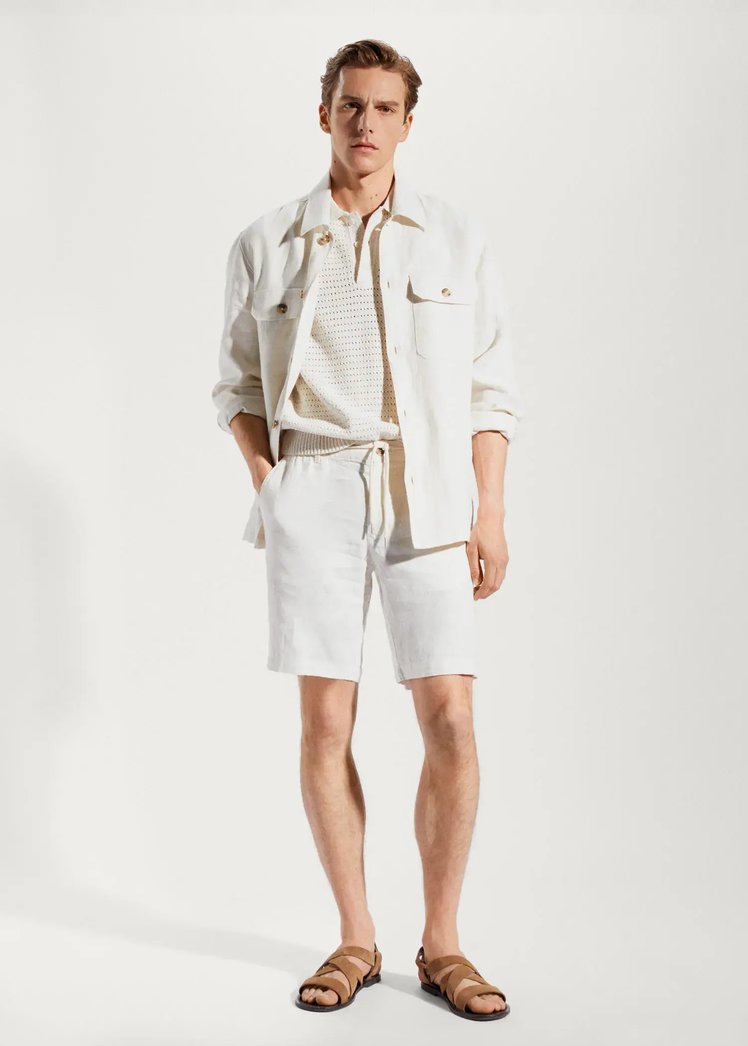 Mango 100% linen regular-fit overshirt. a man in white shorts and a white jacket. 