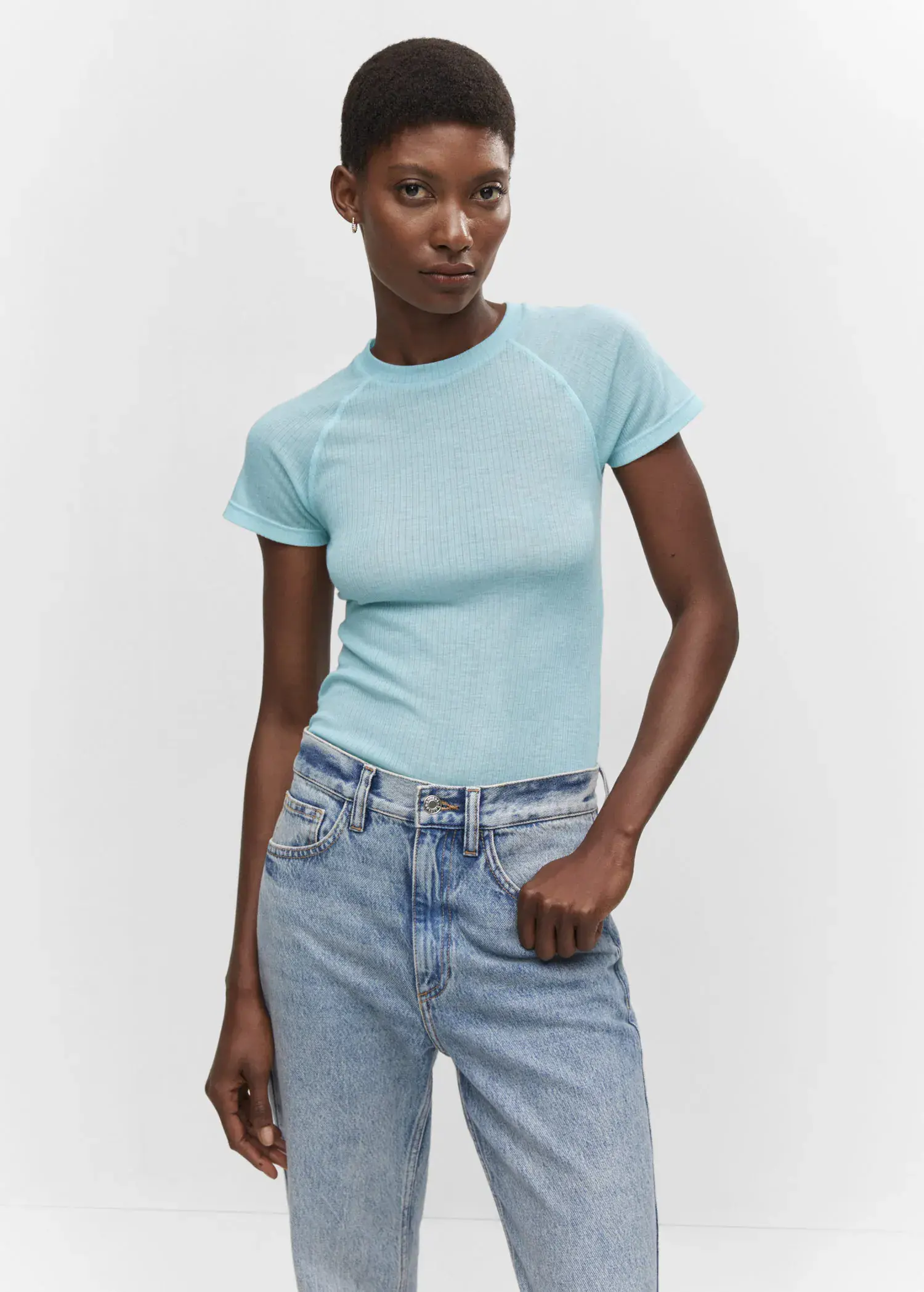 Mango Seam detail T-shirt. a woman wearing a blue shirt and jeans. 