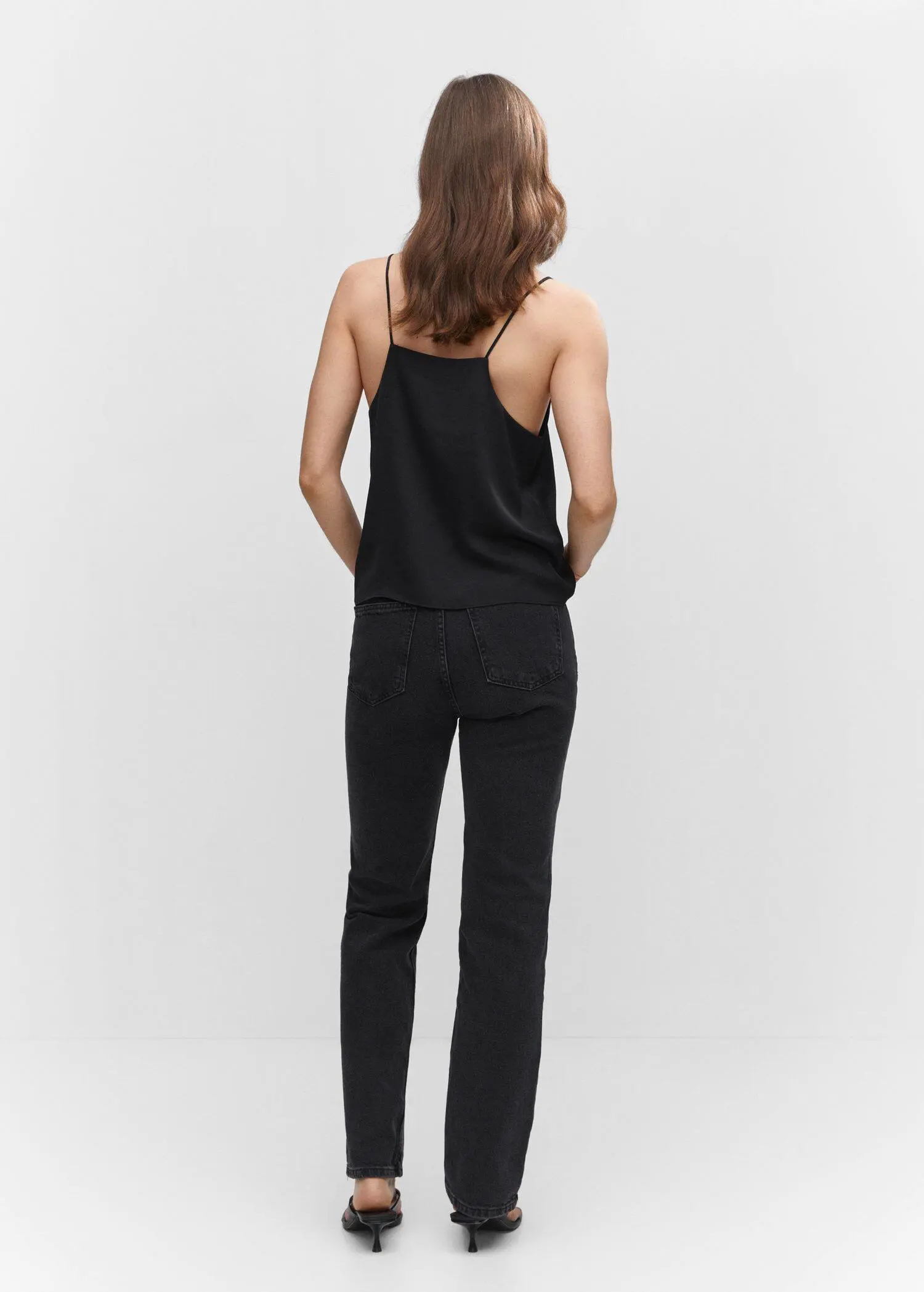 Mango Satin top with straps. a woman wearing a black top and black pants. 