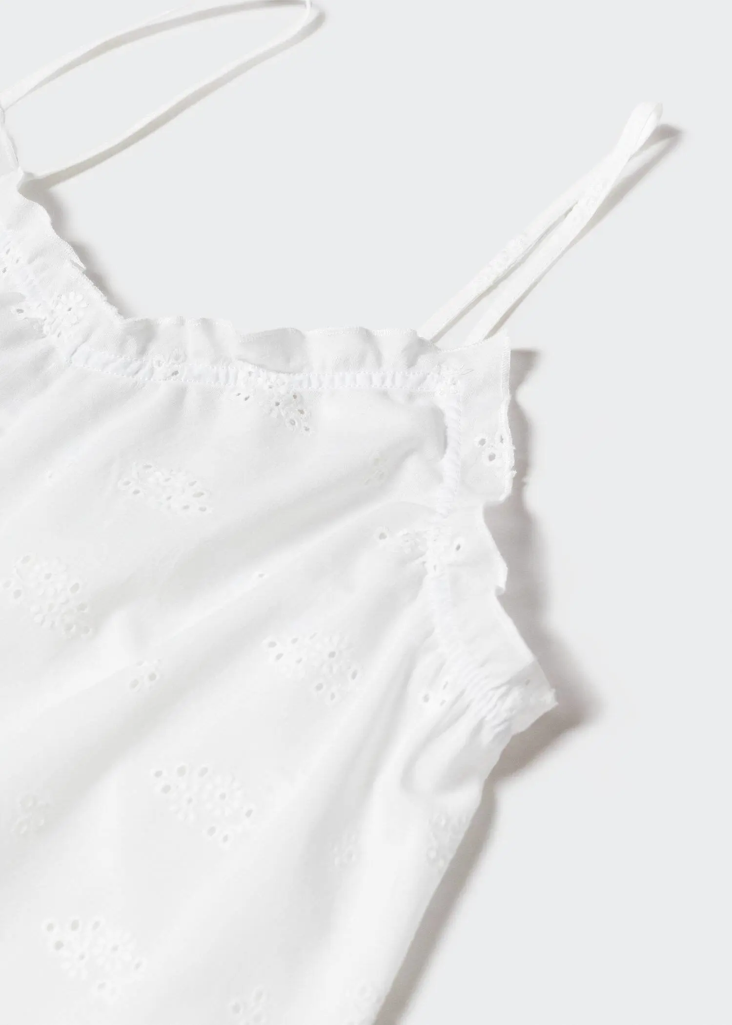 Mango Floral embroidered nightgown. a close-up view of the shoulder straps of a white dress. 