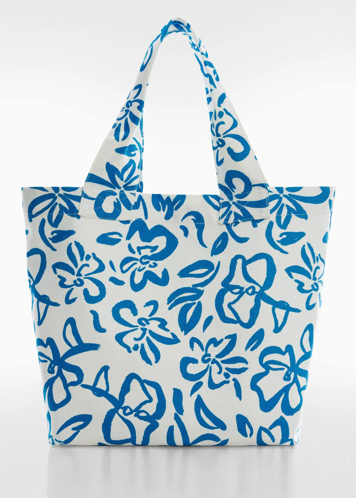 Mango Floral tote bag. a white bag with blue flowers on it. 