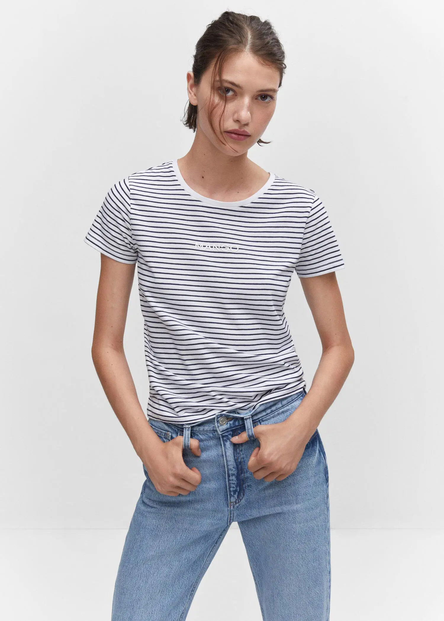 Mango Striped logo T-shirt. a woman wearing a striped shirt and jeans. 
