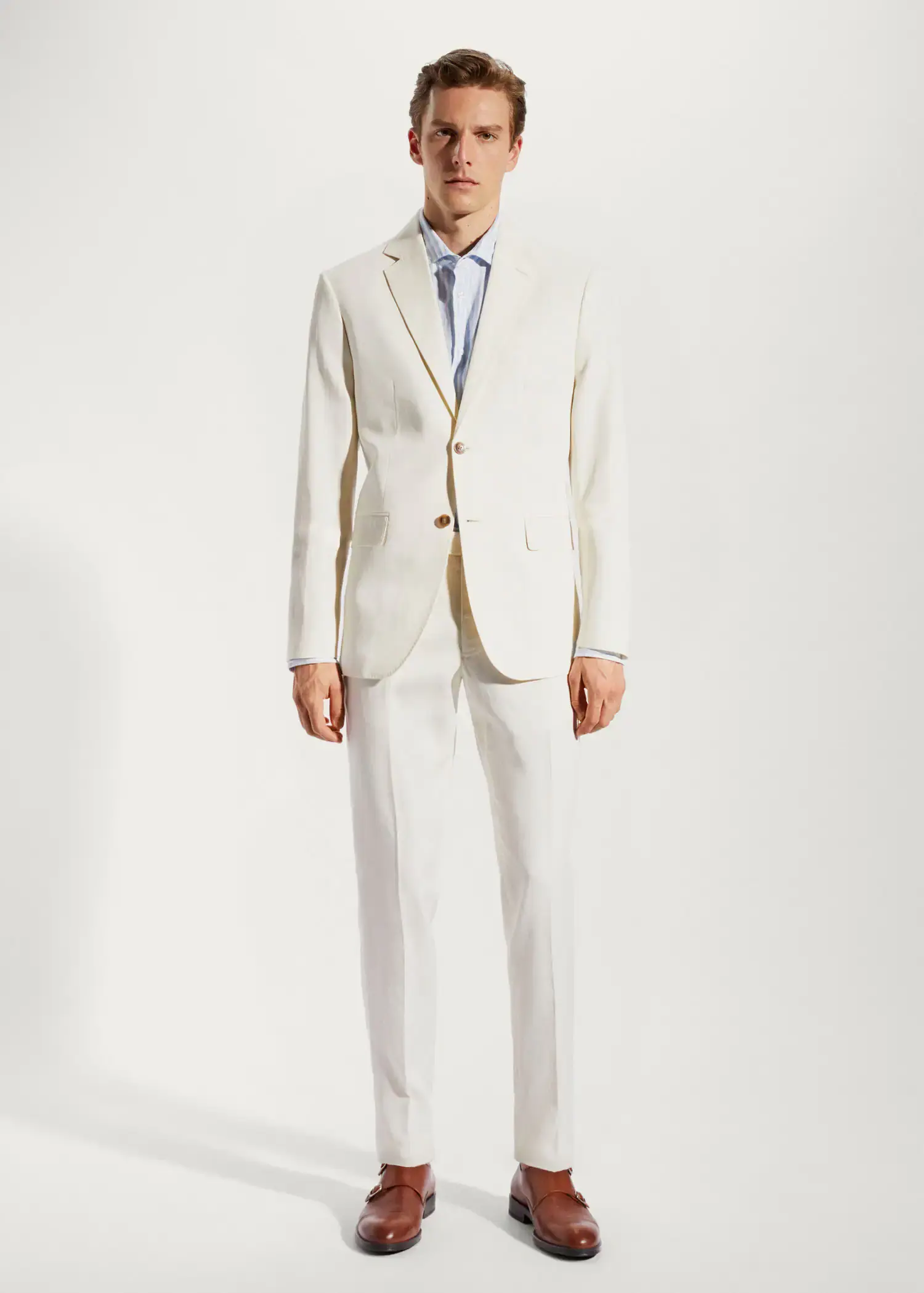 Mango 100% linen suit blazer. a man in a white suit standing in front of a white wall. 