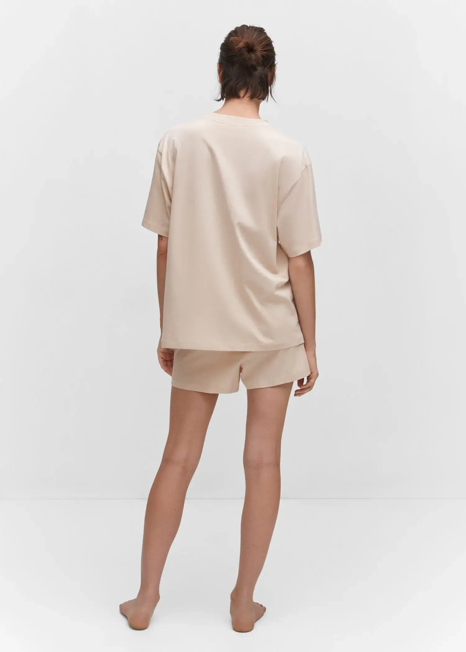 Mango Short cotton pyjamas. a person standing in a room wearing a beige outfit. 